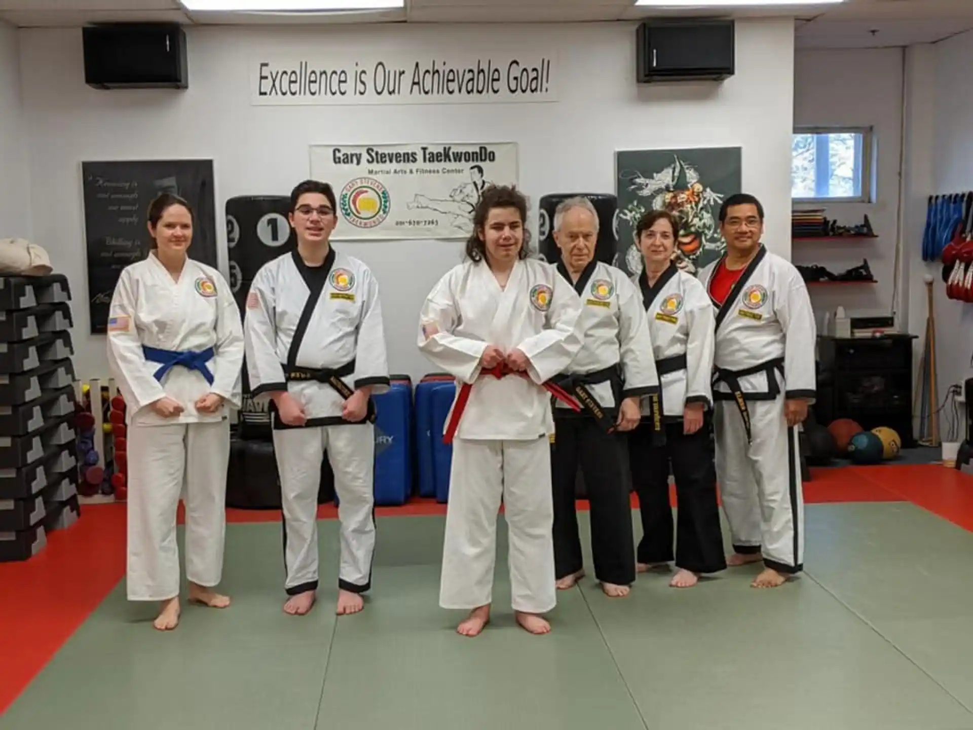 a group of people in white karate uniforms