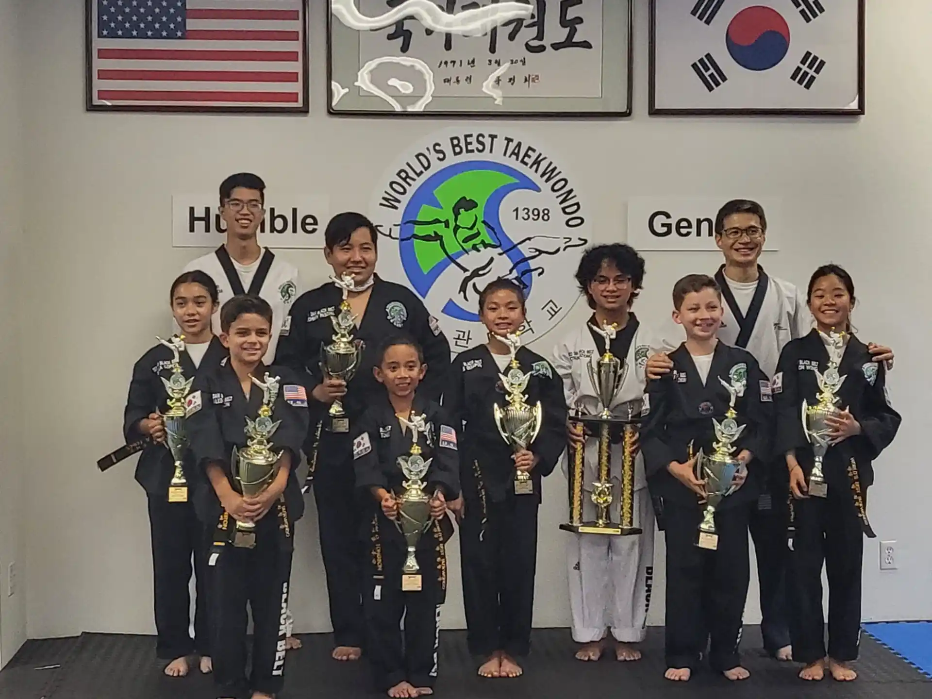a group of people holding trophies