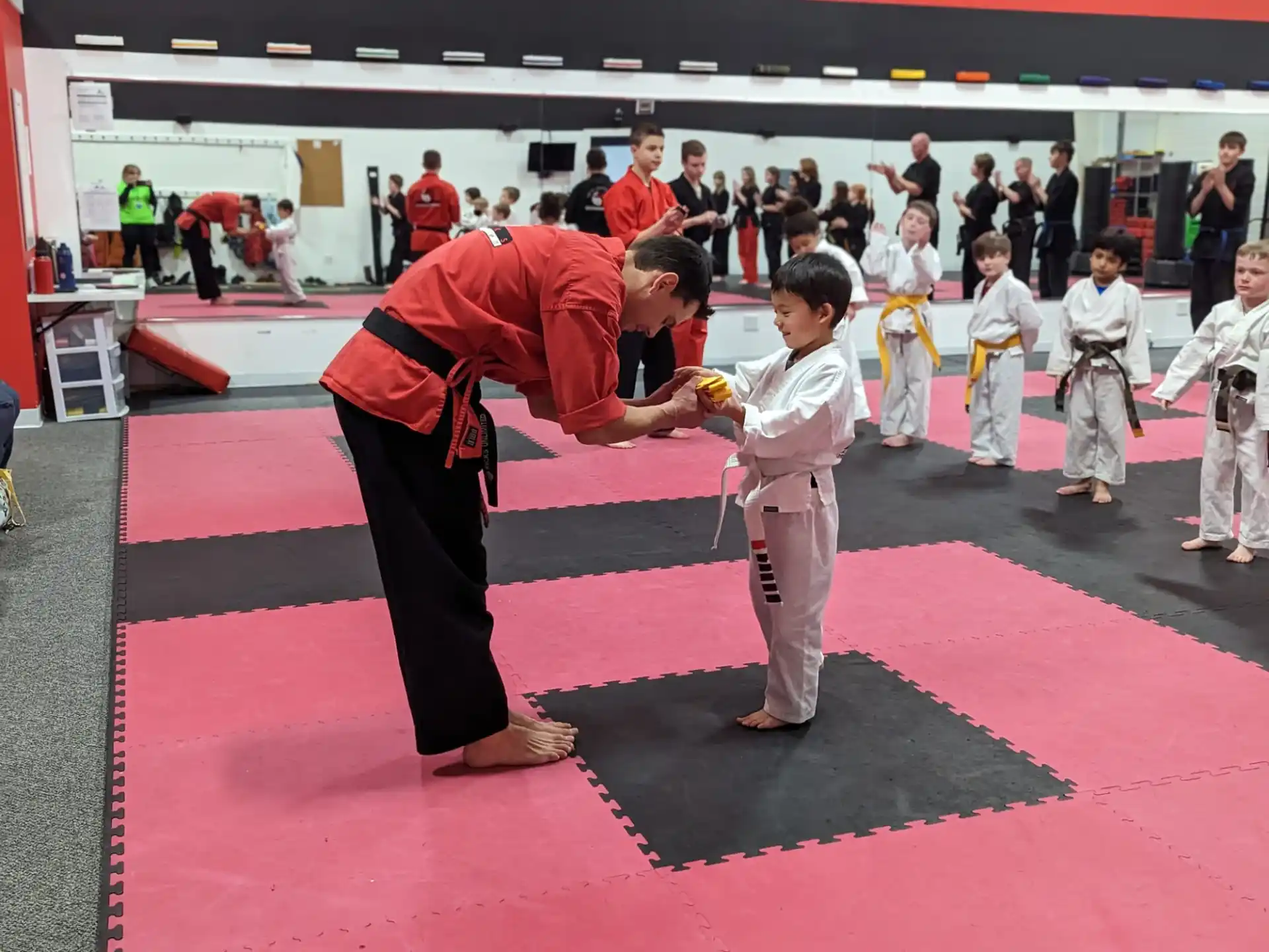 a person and a boy in karate uniforms