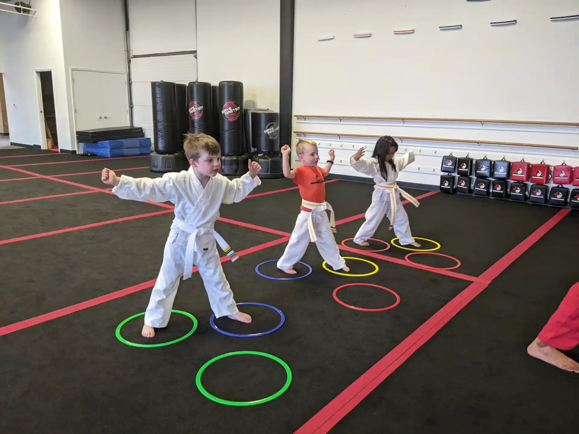 children in karate uniforms in a room