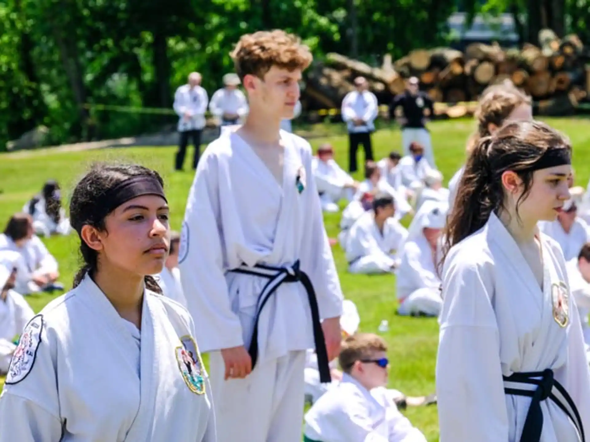 a group of people in white karate uniforms