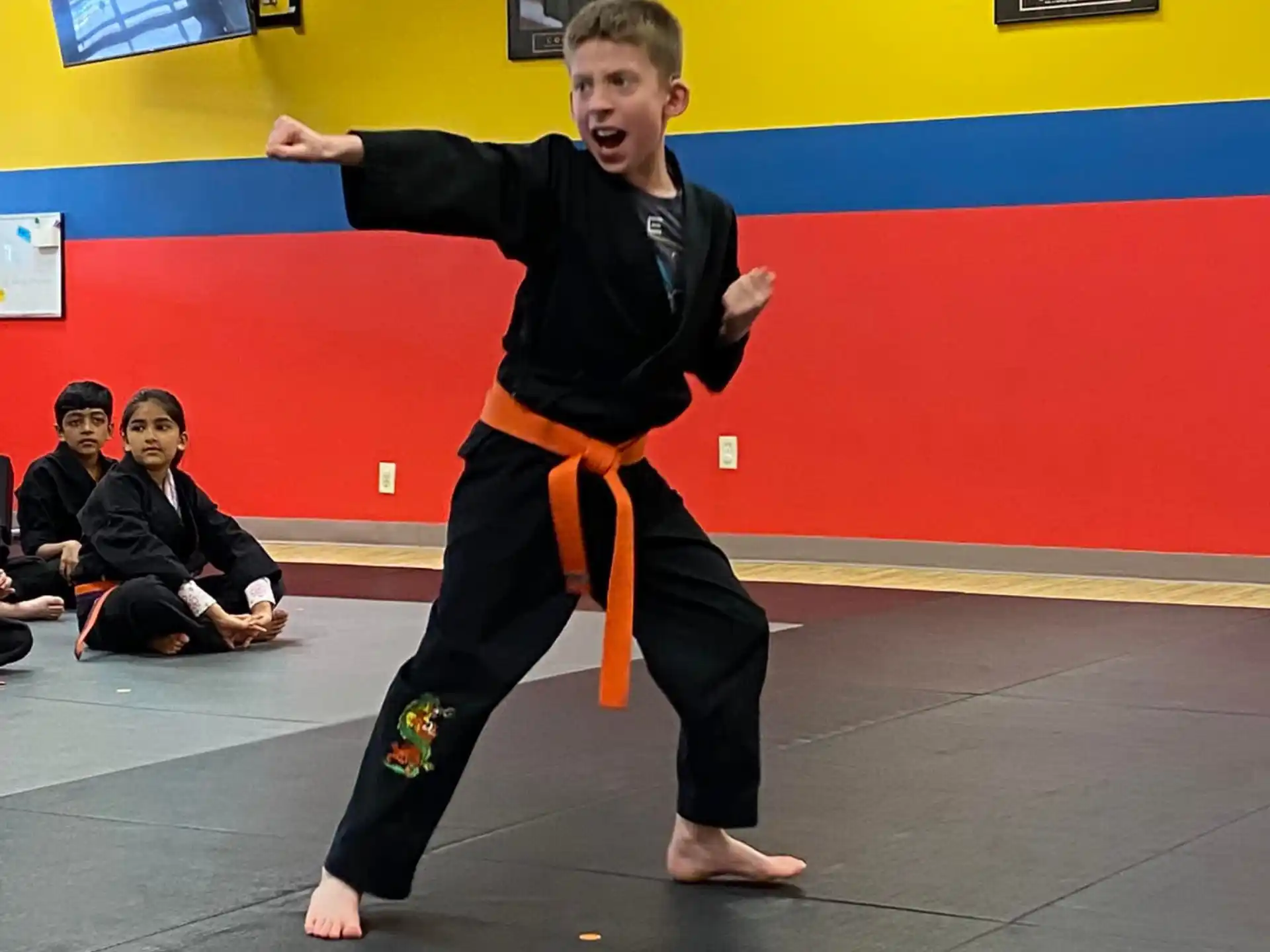 a boy in a martial arts uniform