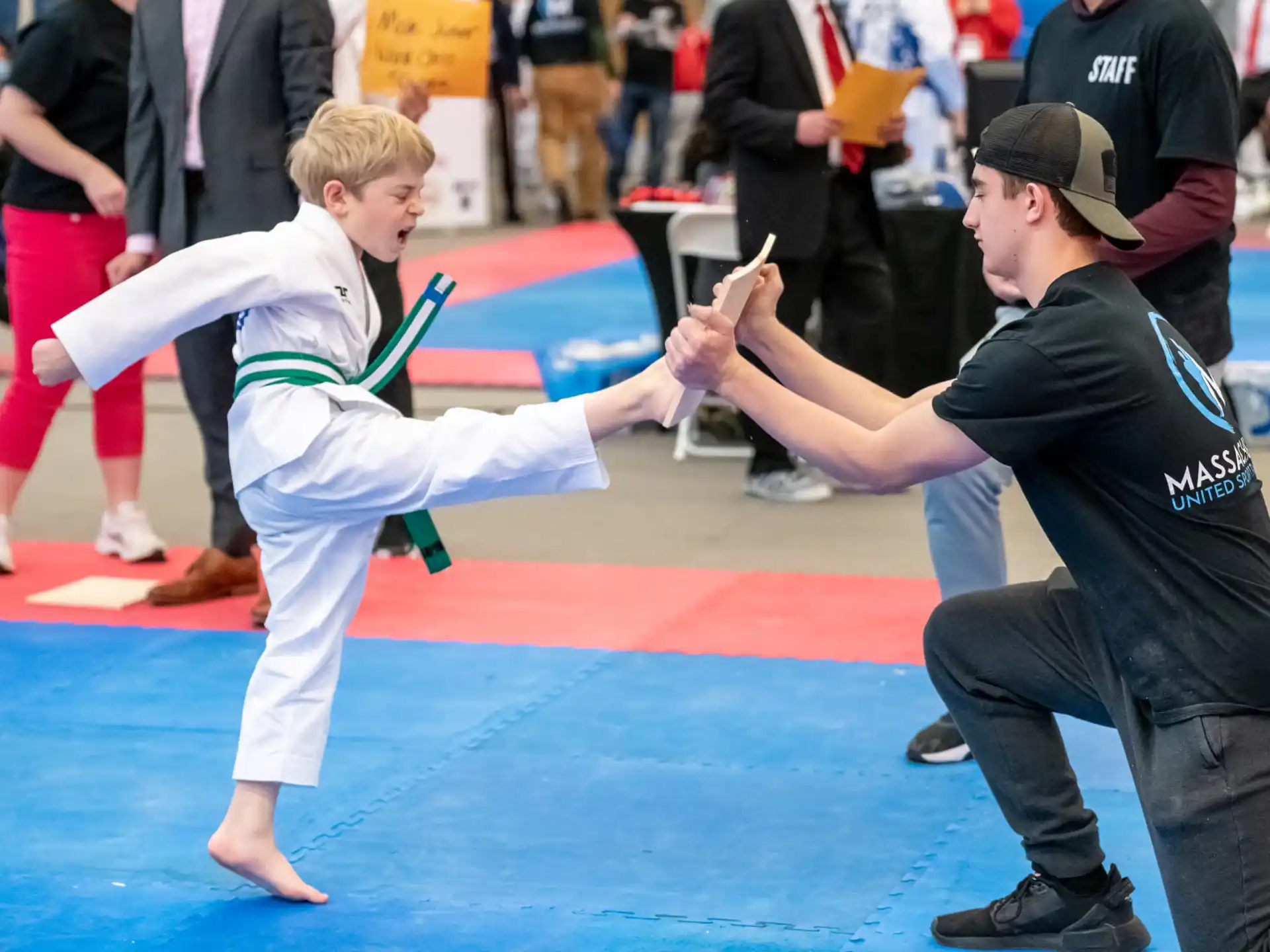 a person and a boy practicing karate