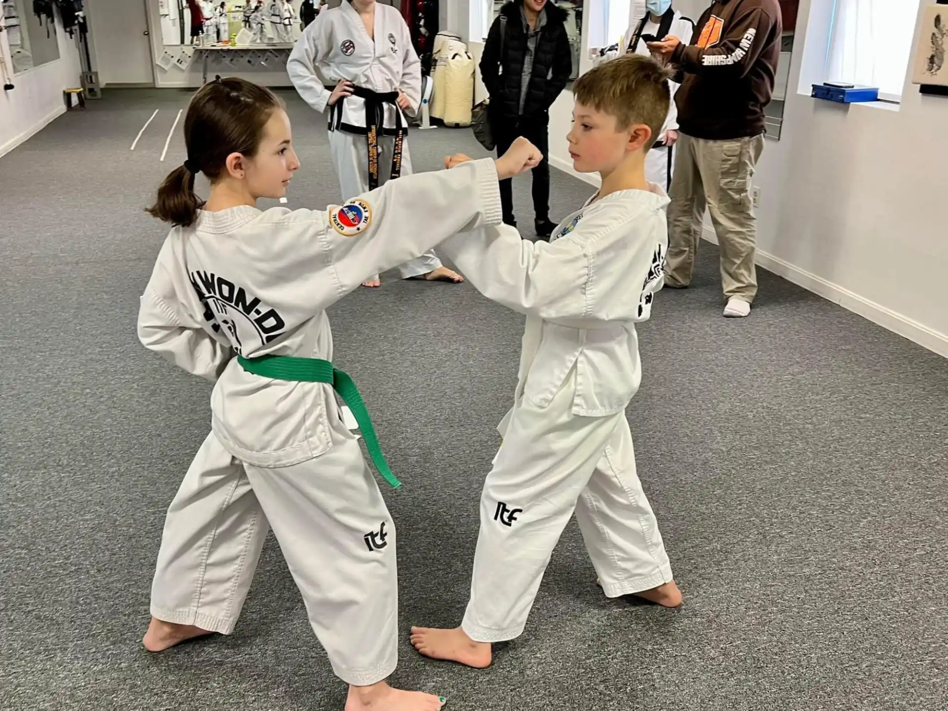 a couple of children in karate uniforms