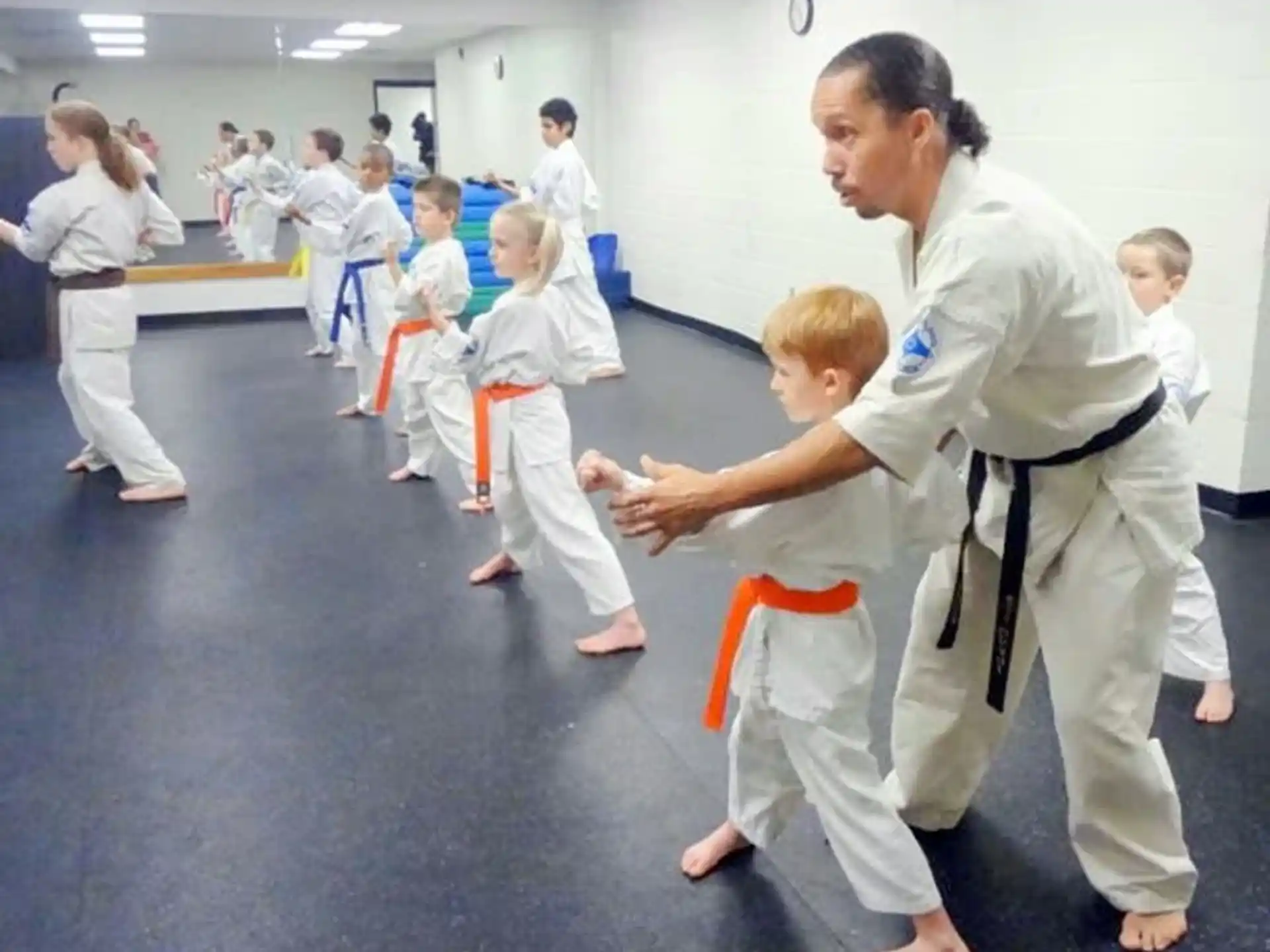 a group of people in white karate uniforms