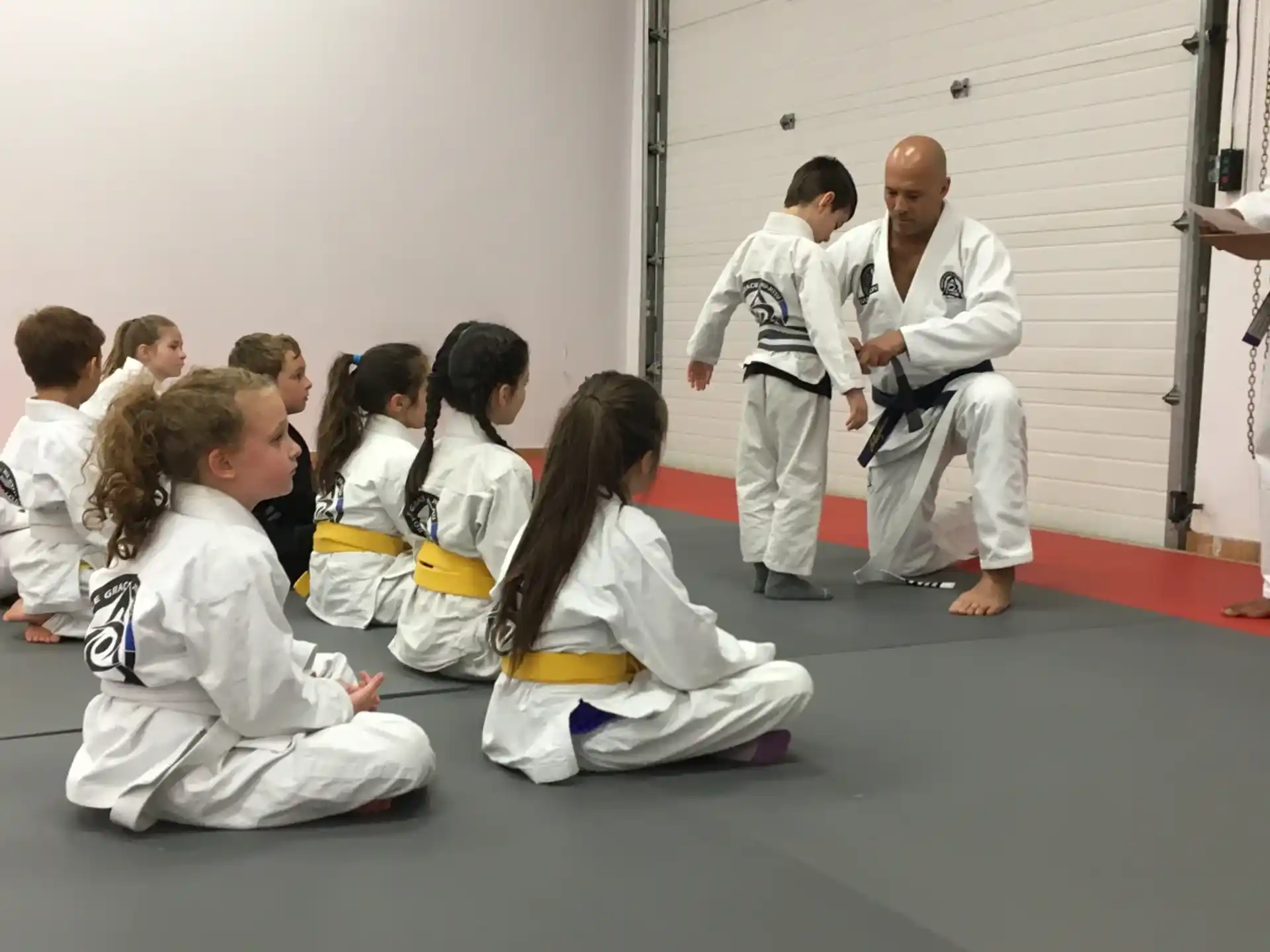a group of people in white karate uniforms