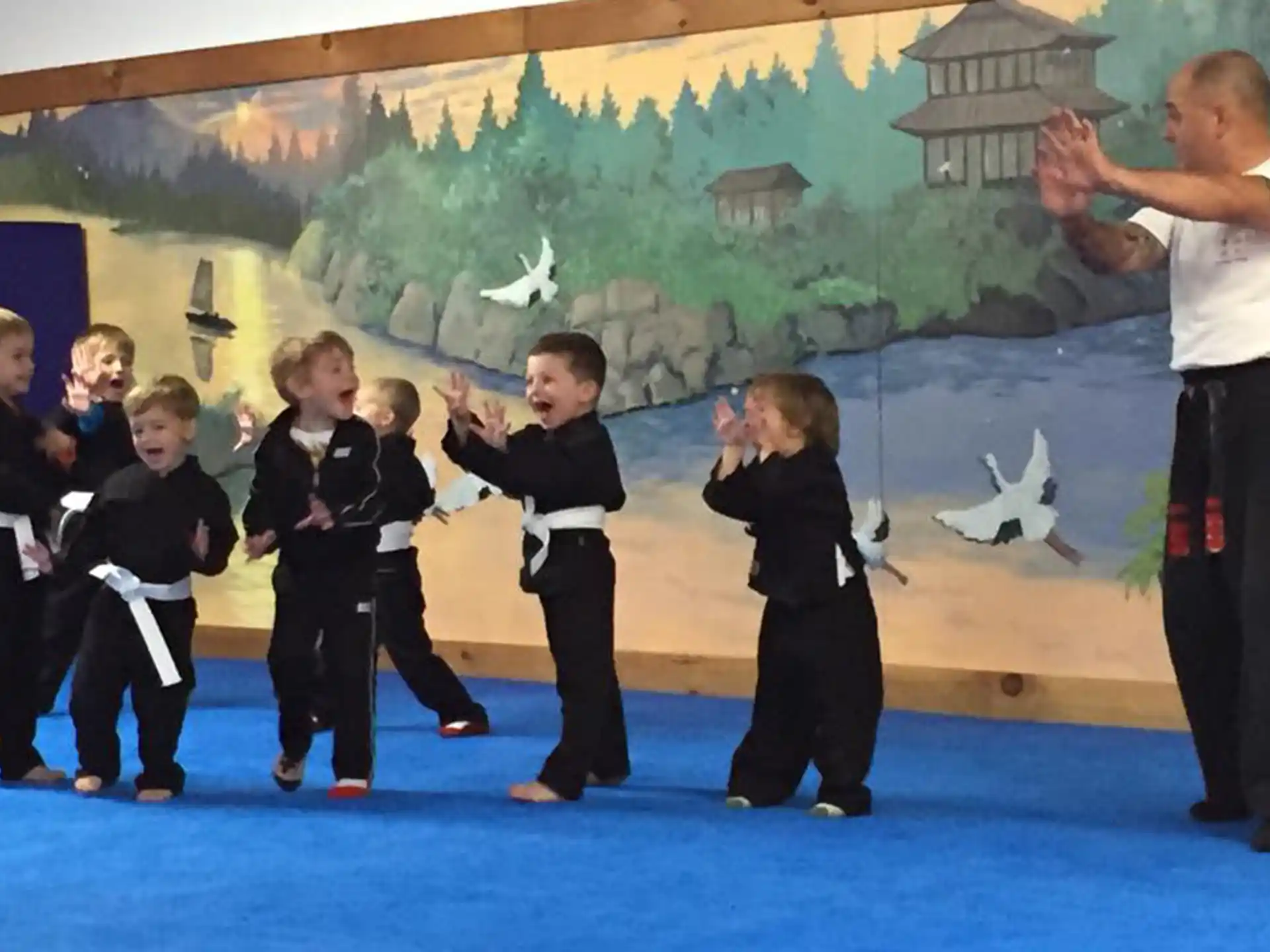 a group of children in black karate uniforms