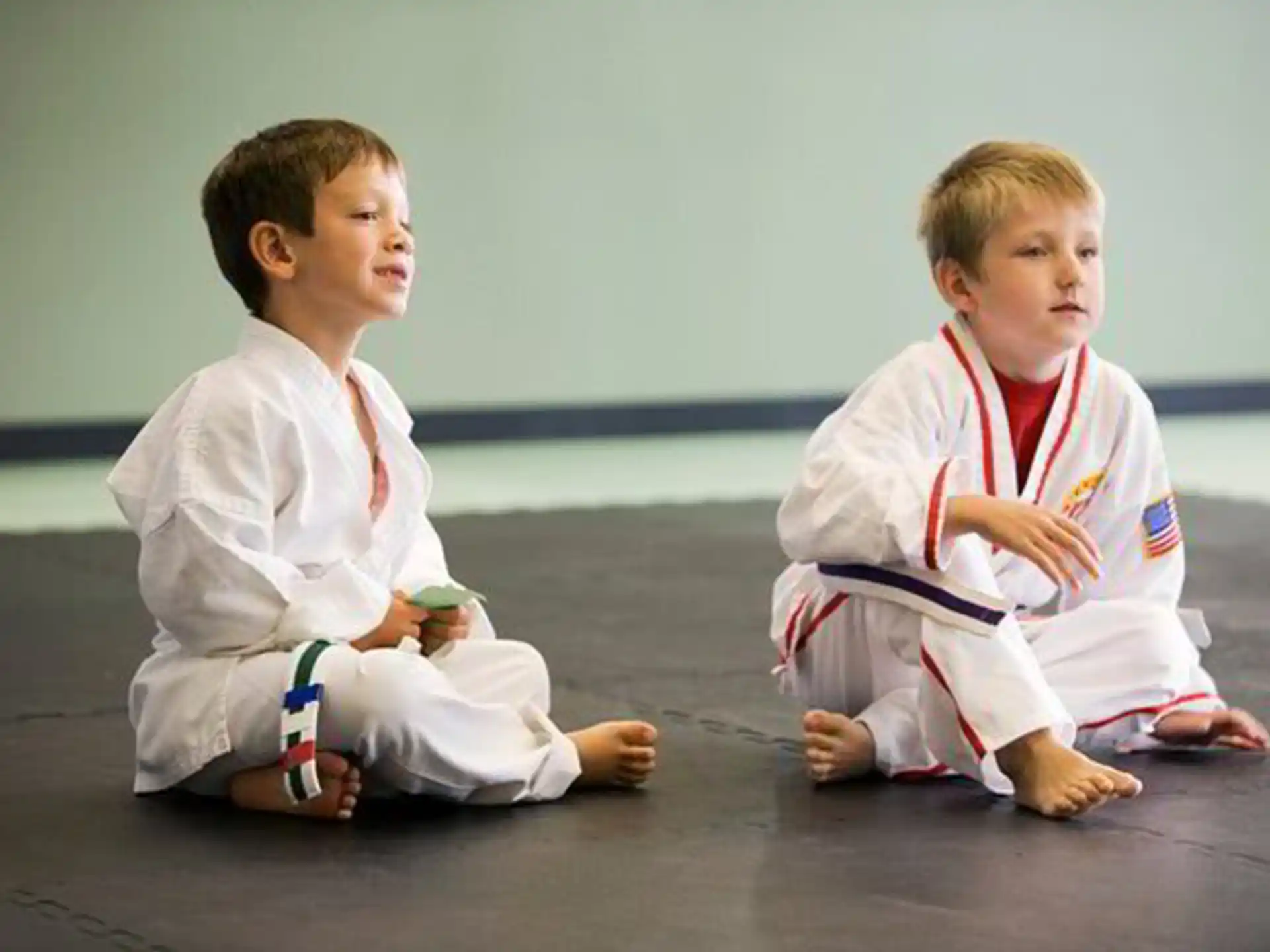 two boys sitting on the floor