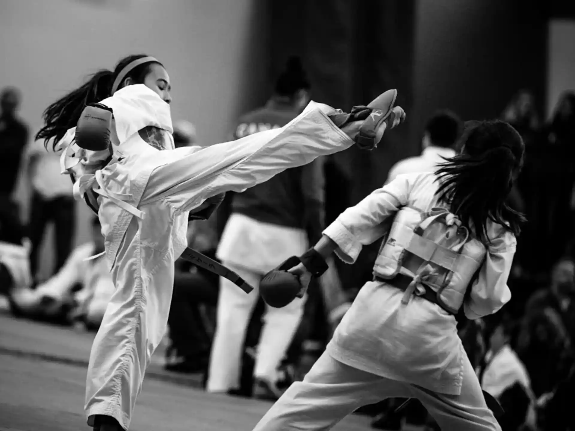 a couple of women in karate uniforms