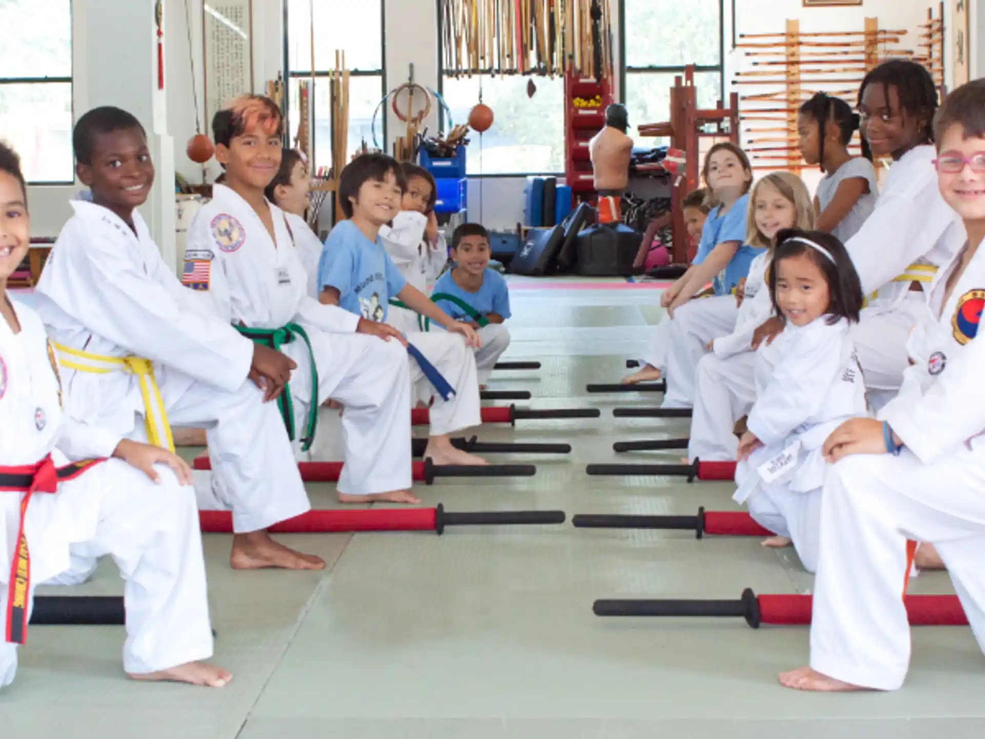 a group of children in karate uniforms