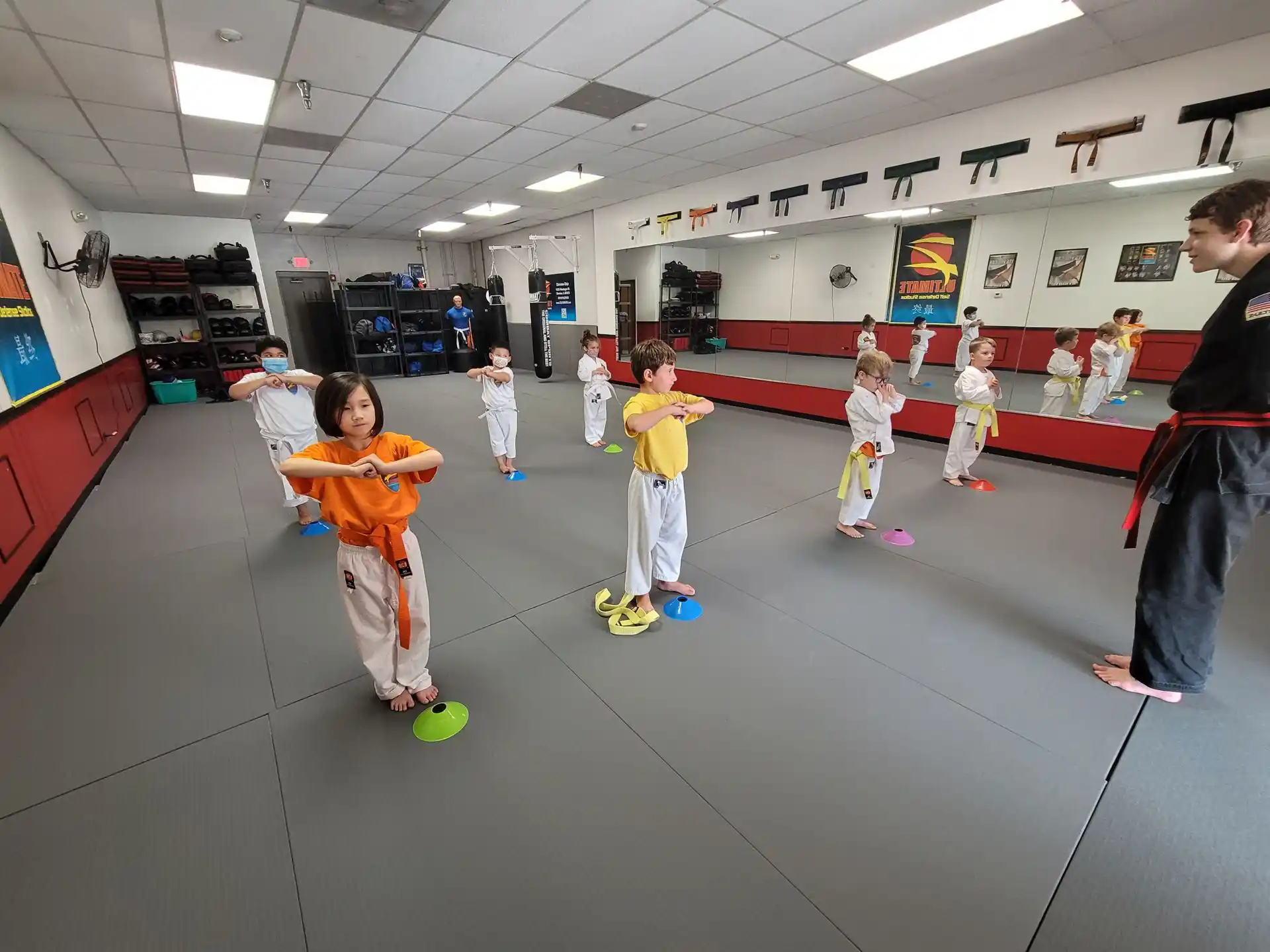 a group of children playing in a room with a man and a woman