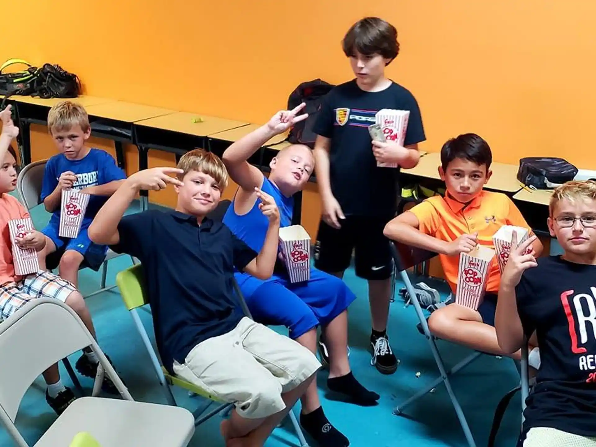 a group of boys sitting in chairs
