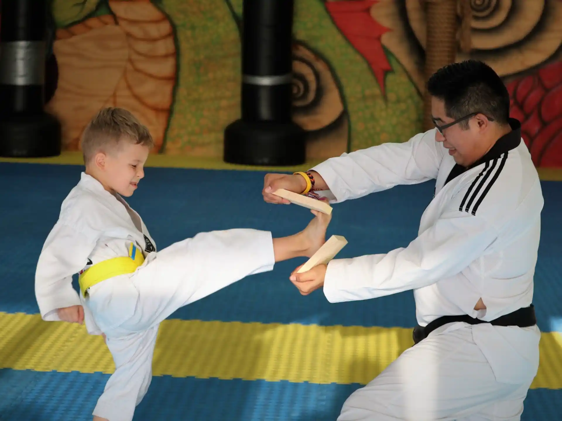 a person and a boy in karate uniforms