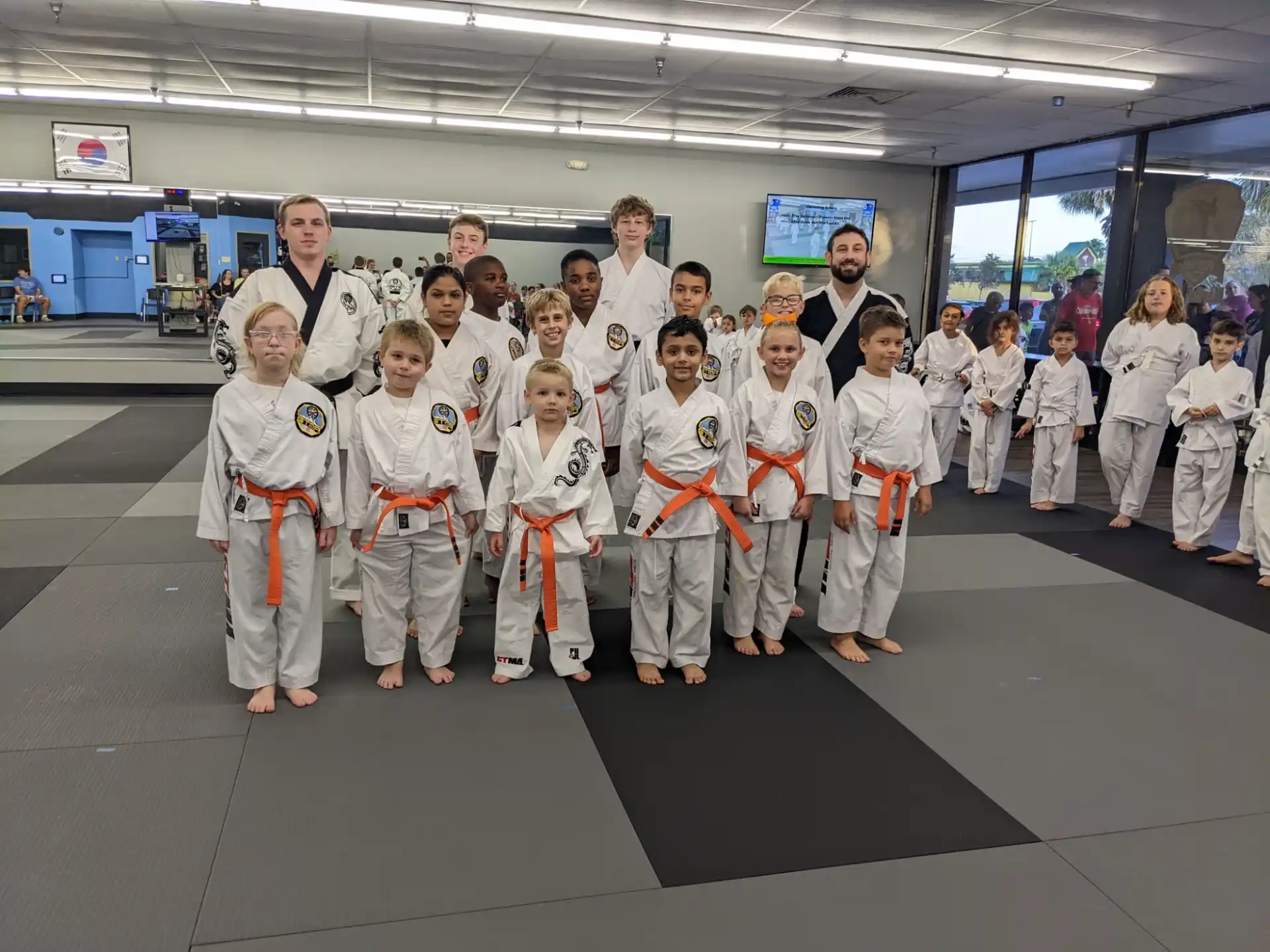 a group of people in white karate uniforms