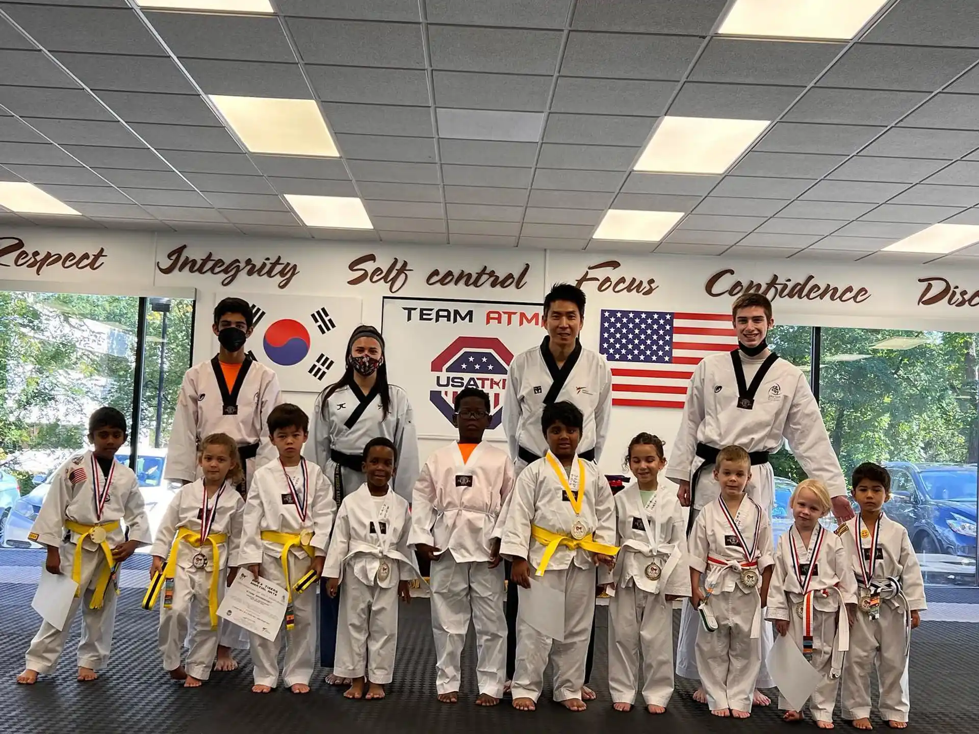 a group of people wearing white karate uniforms