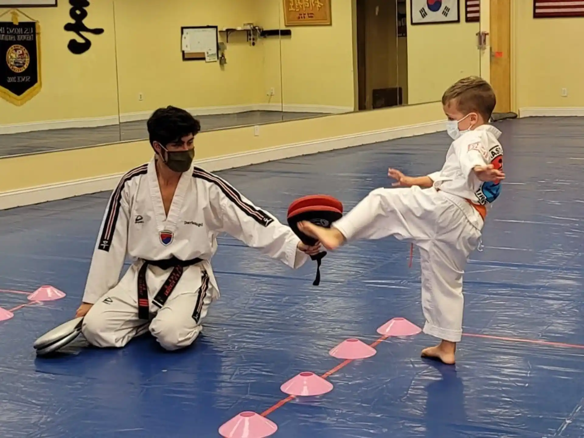 a person and a boy in karate uniforms
