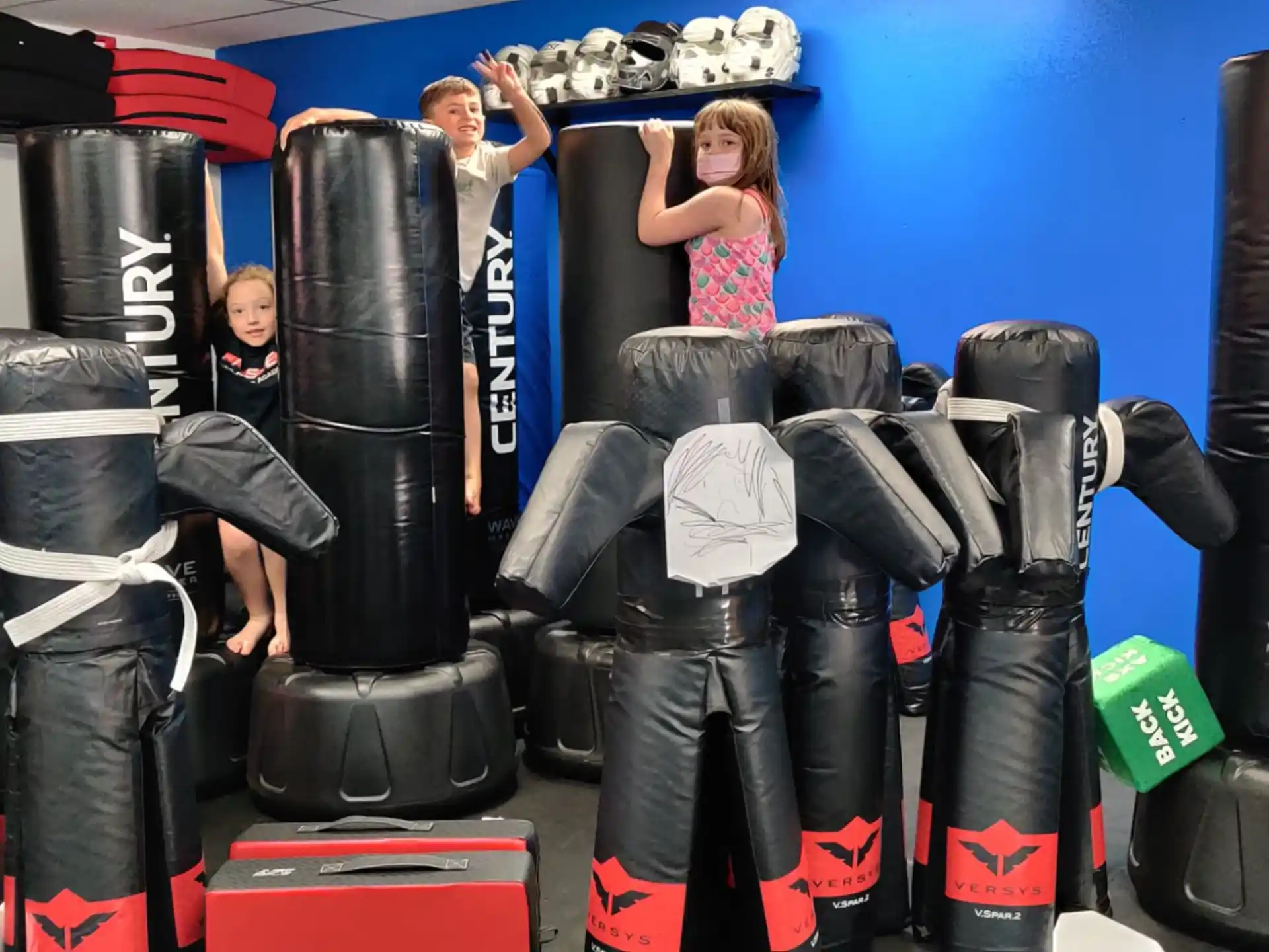 a group of people in a room with large tires