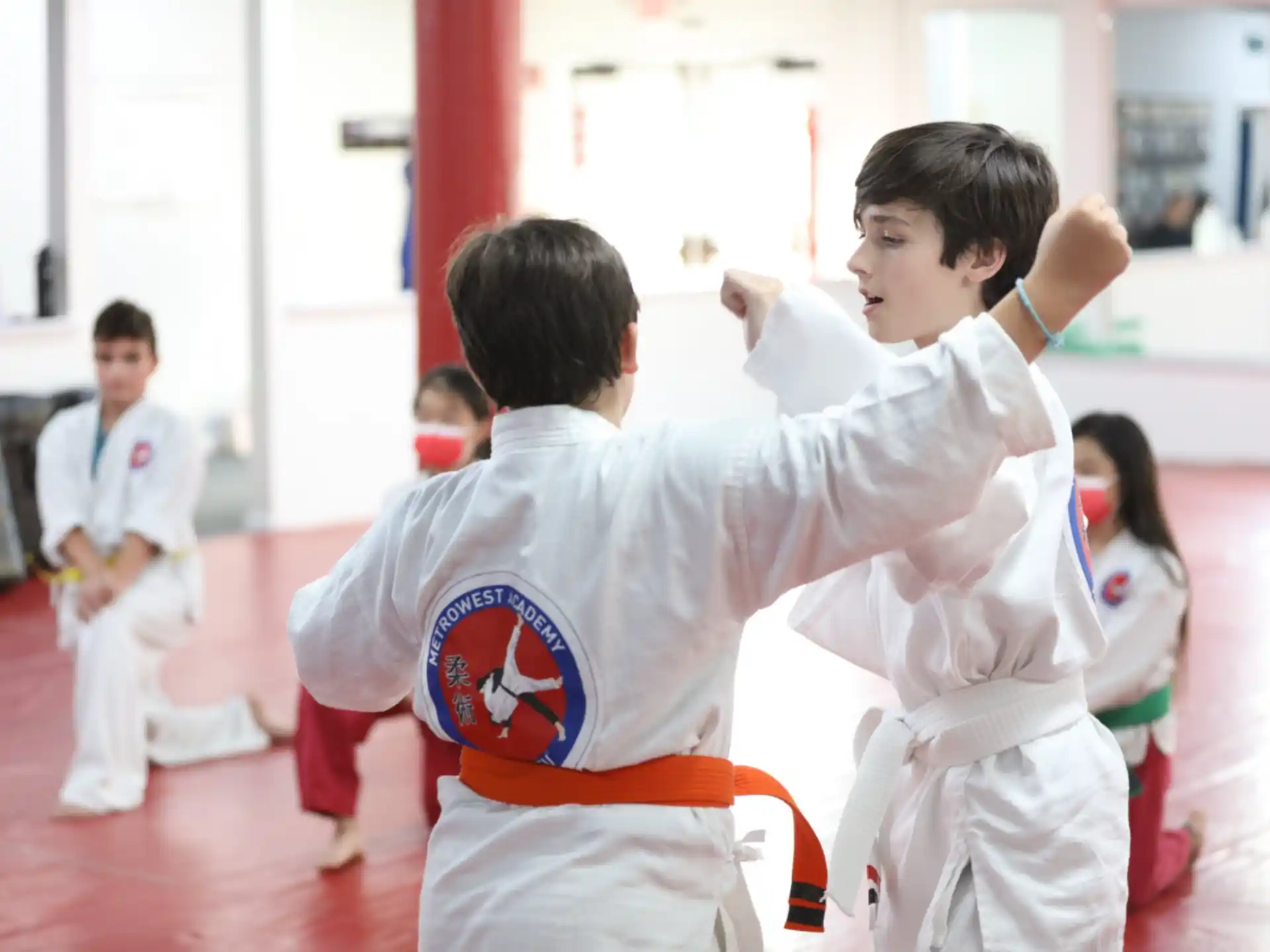 a group of children in karate uniforms