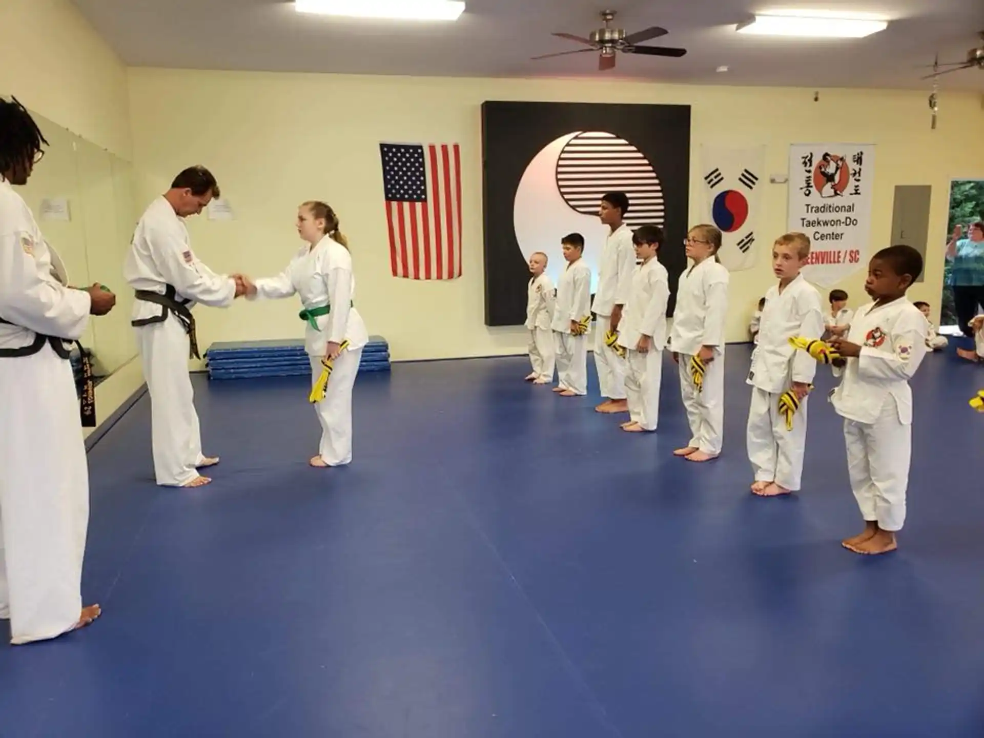 a group of people in white karate uniforms