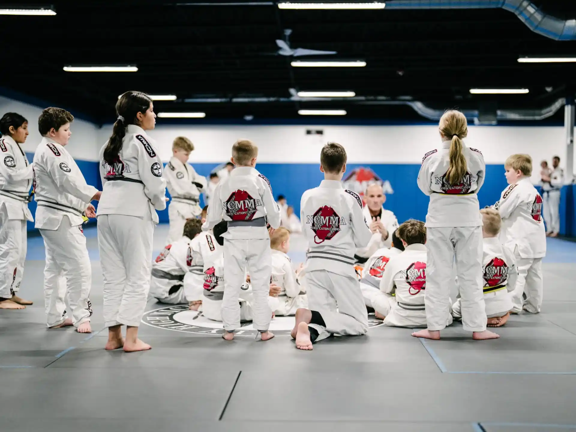 a group of people in white karate uniforms