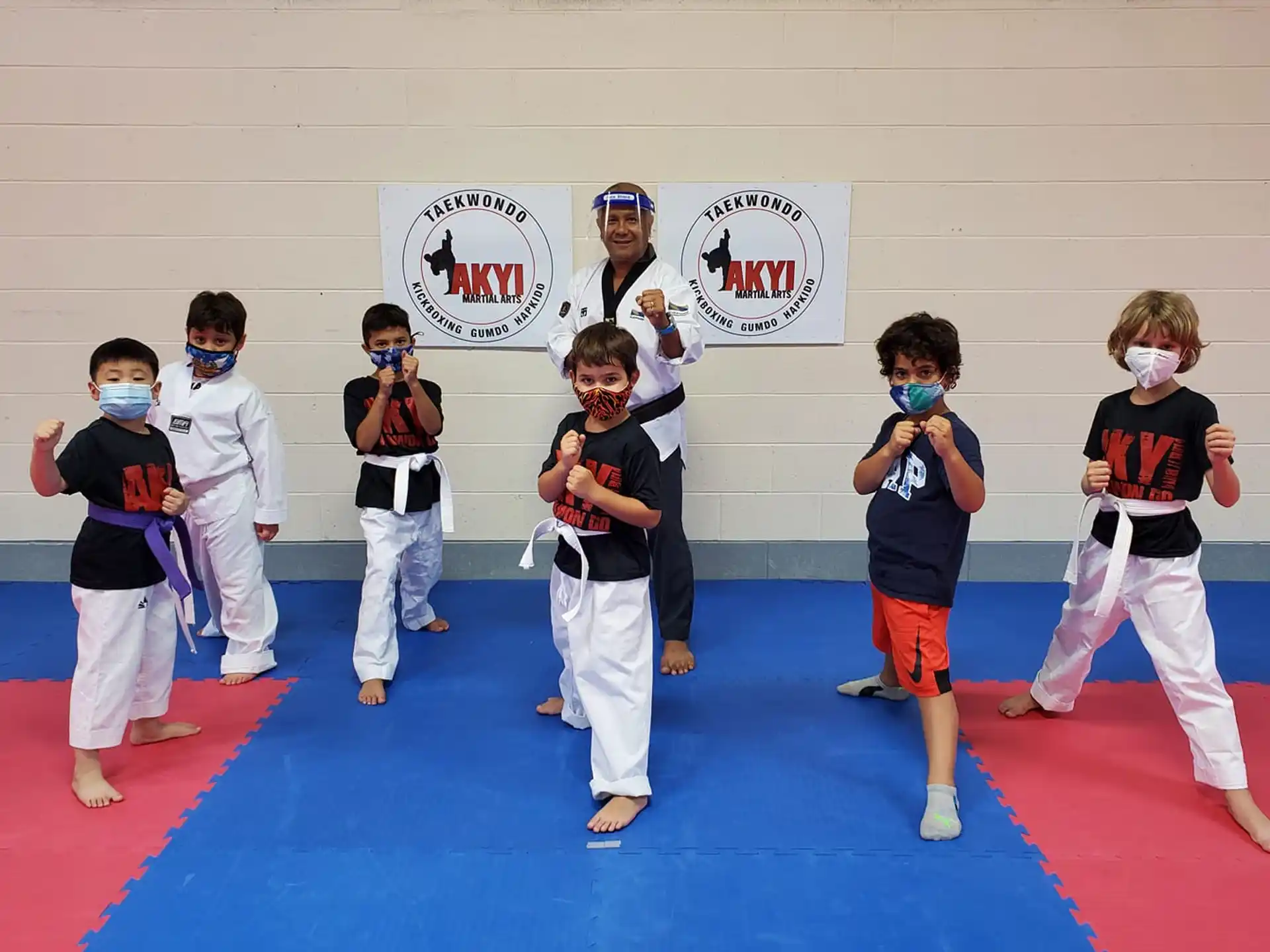 a group of kids in karate uniforms