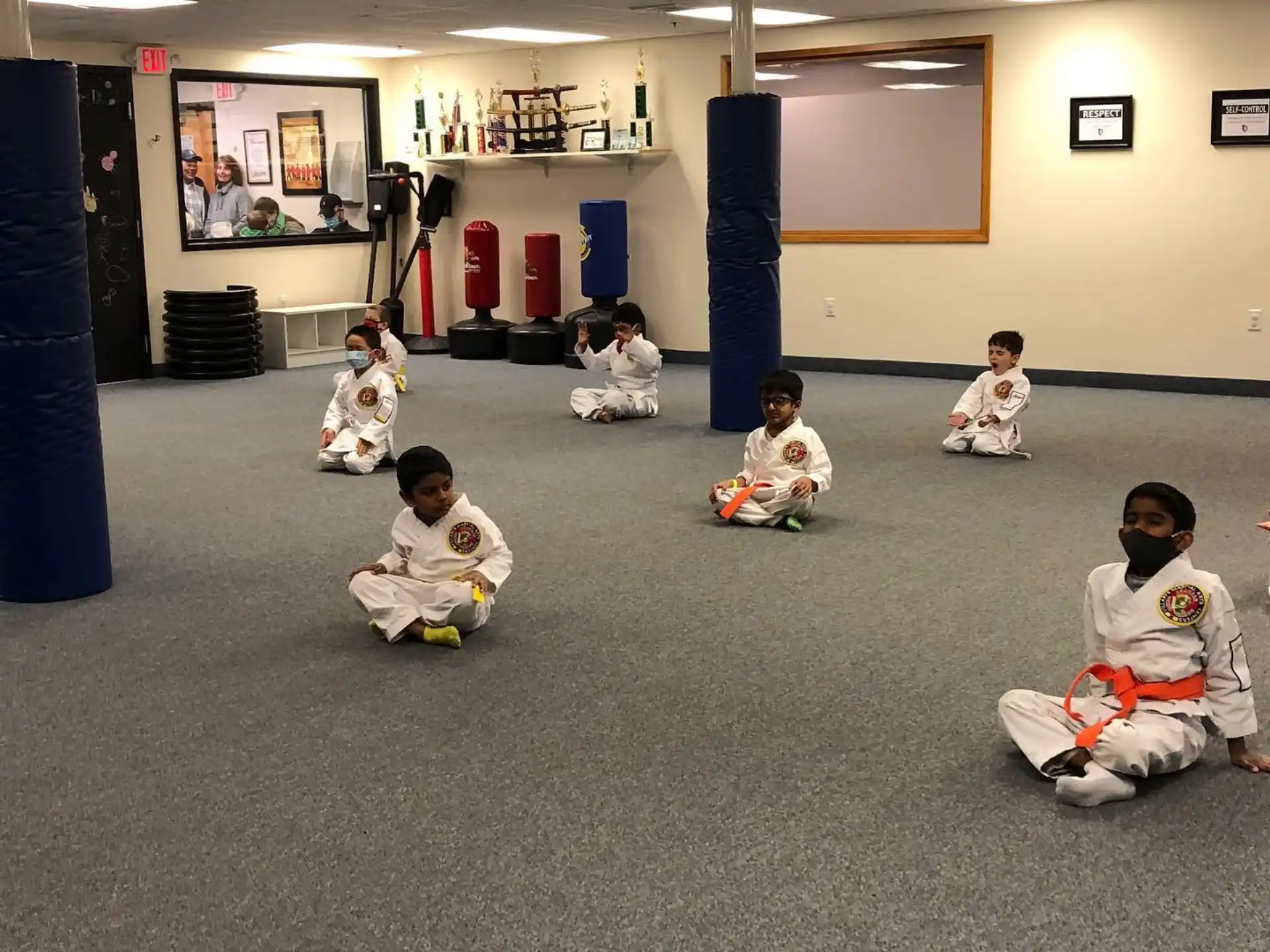 a group of children sitting on the floor in a room