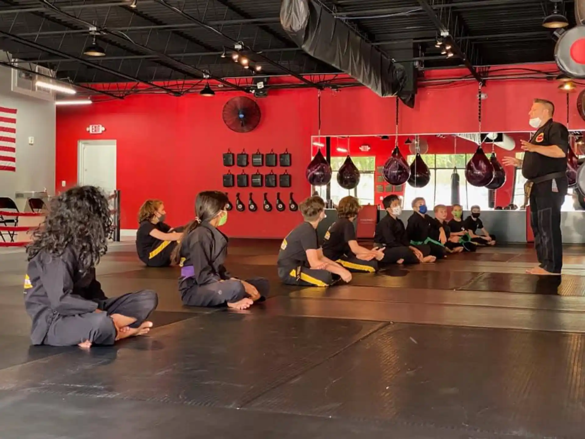 a group of people sitting on the floor in front of a stage