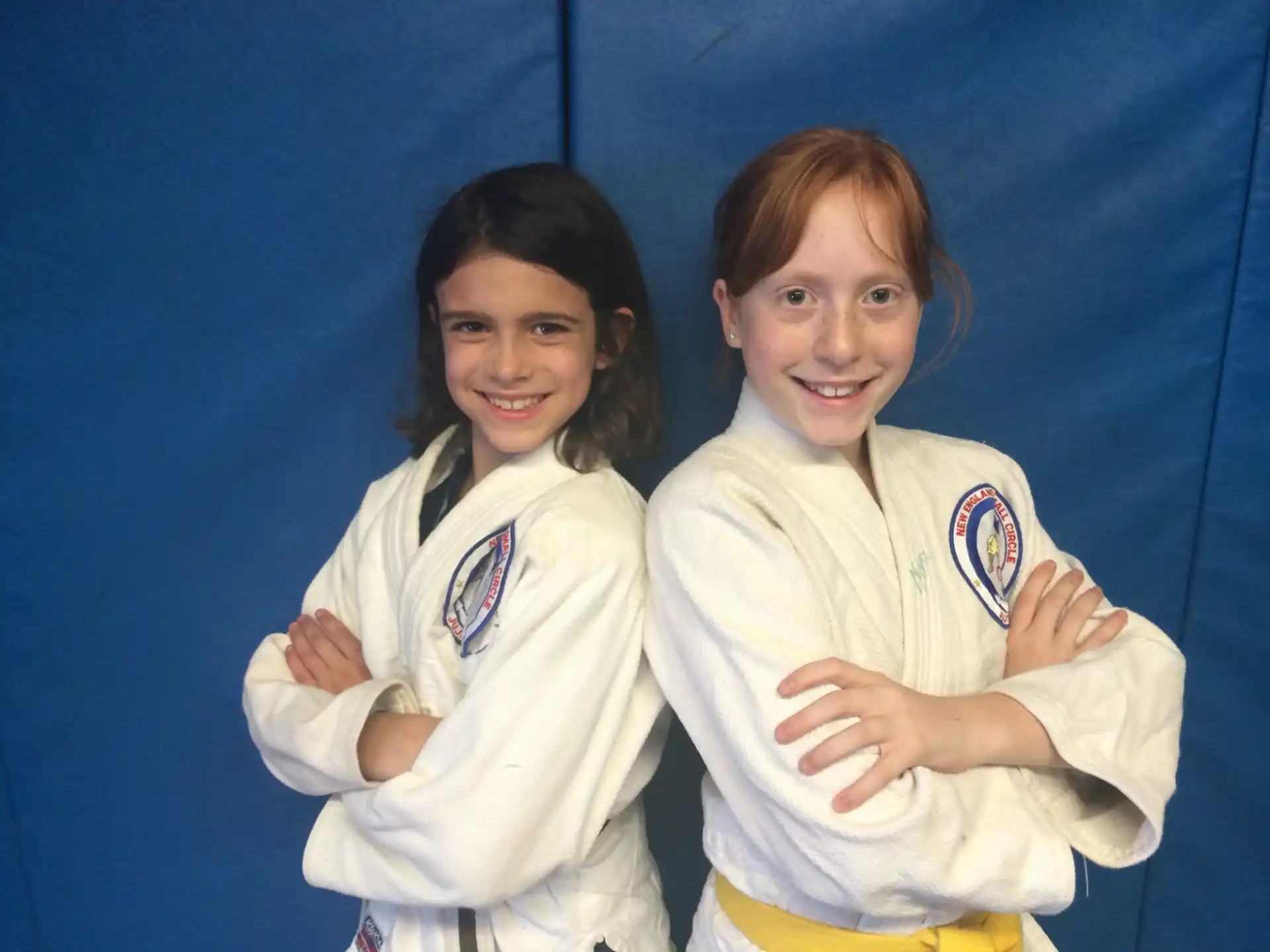 two girls in karate uniforms