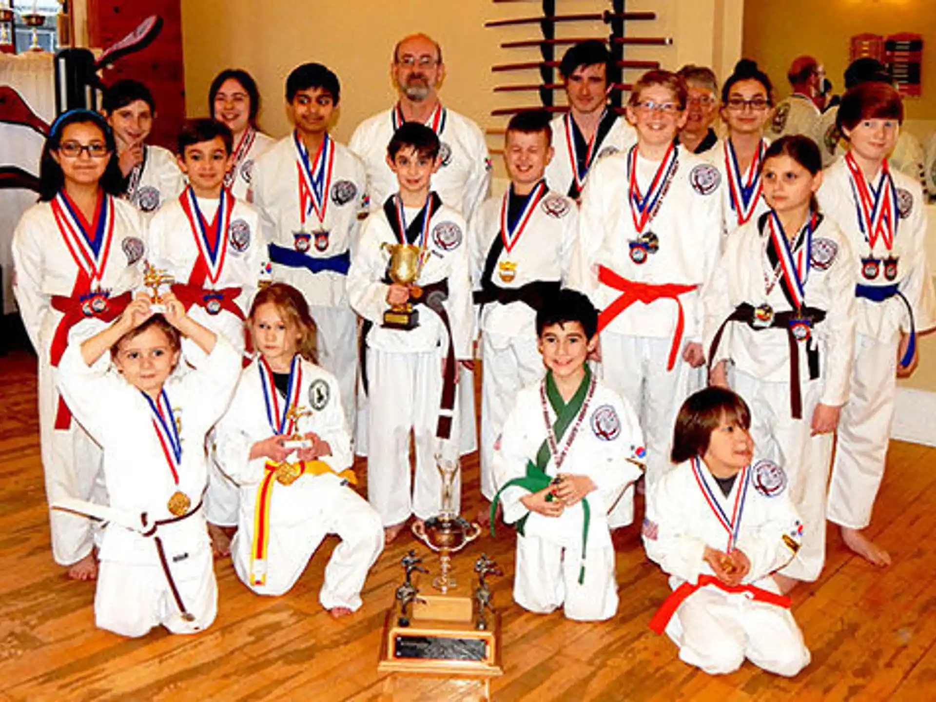 a group of people wearing medals and posing for a photo
