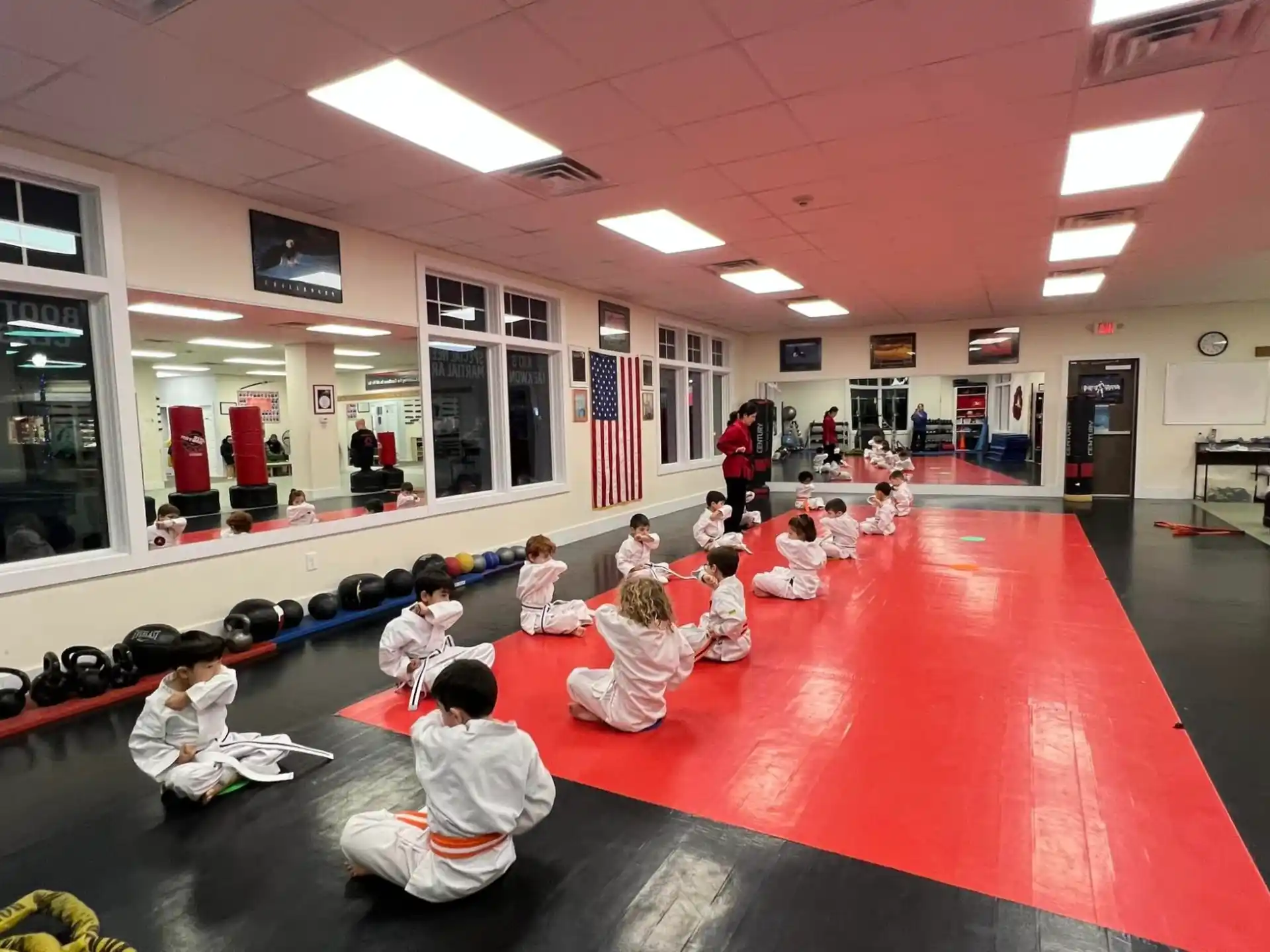 a group of children sitting on the floor in a room