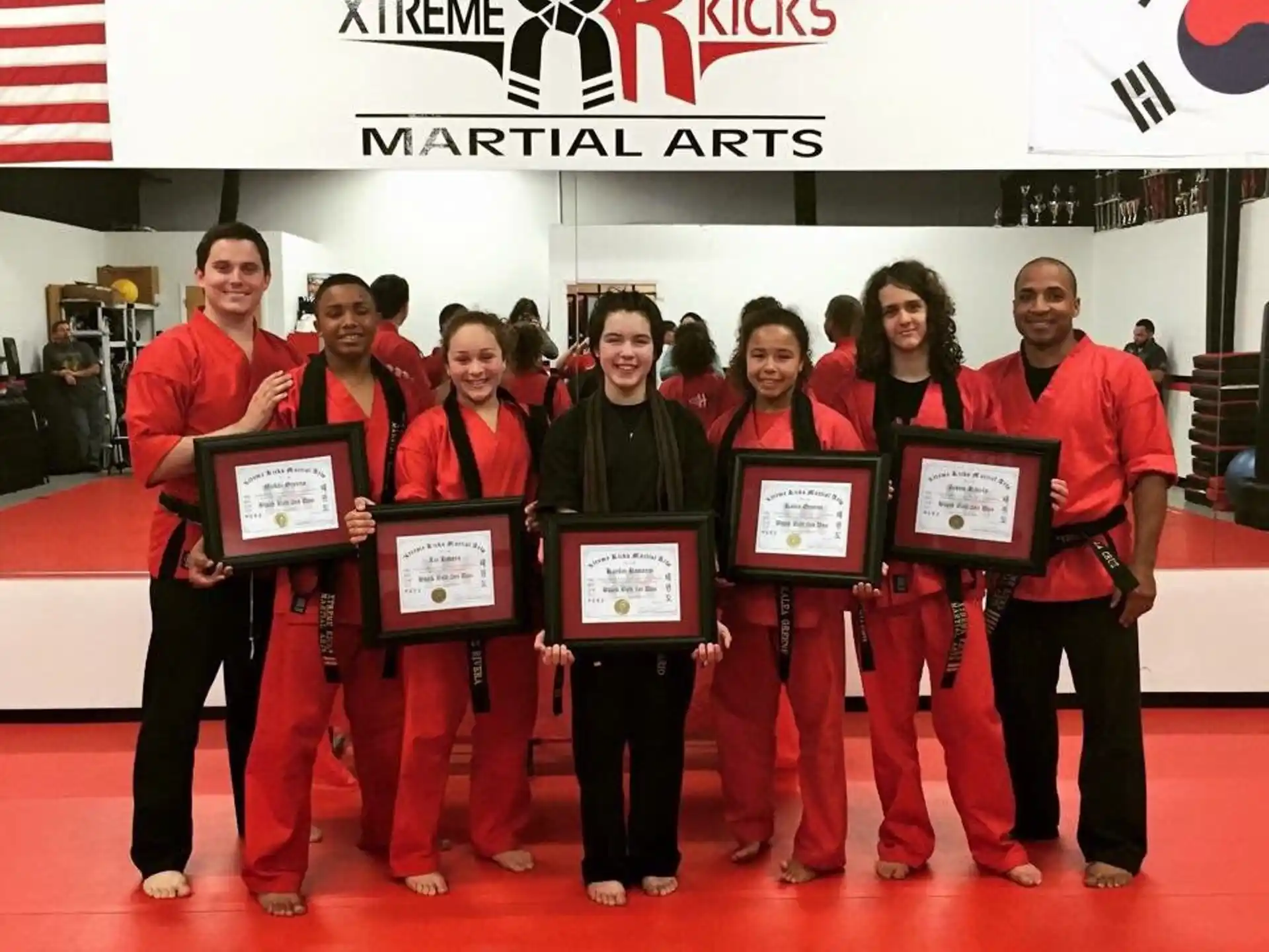 a group of people holding certificates