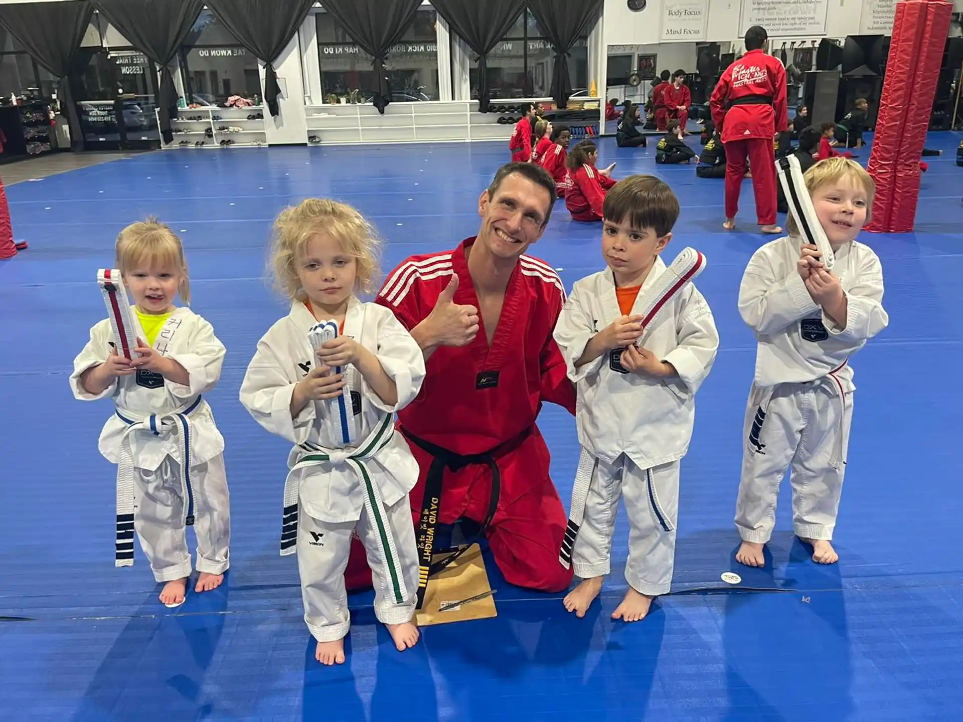 a group of kids in karate uniforms