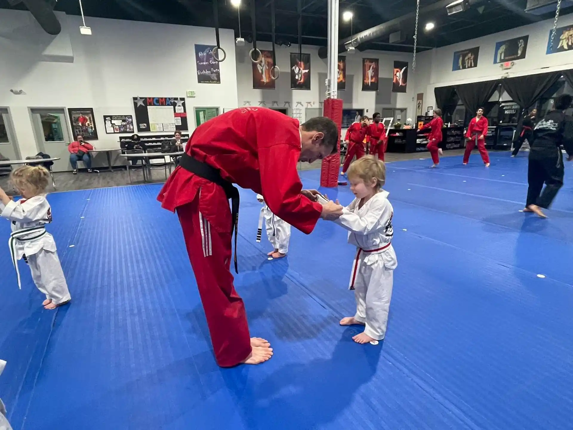 a person in a red suit and a boy in a karate uniform