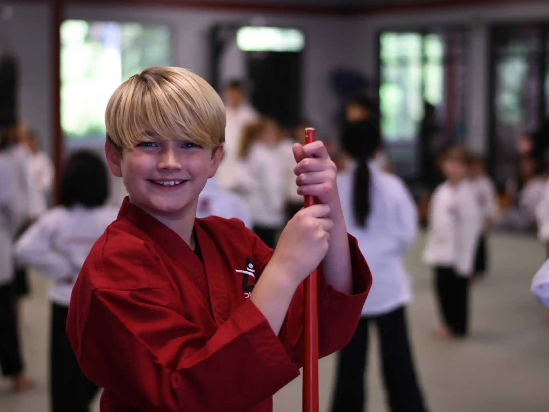 a boy holding a stick