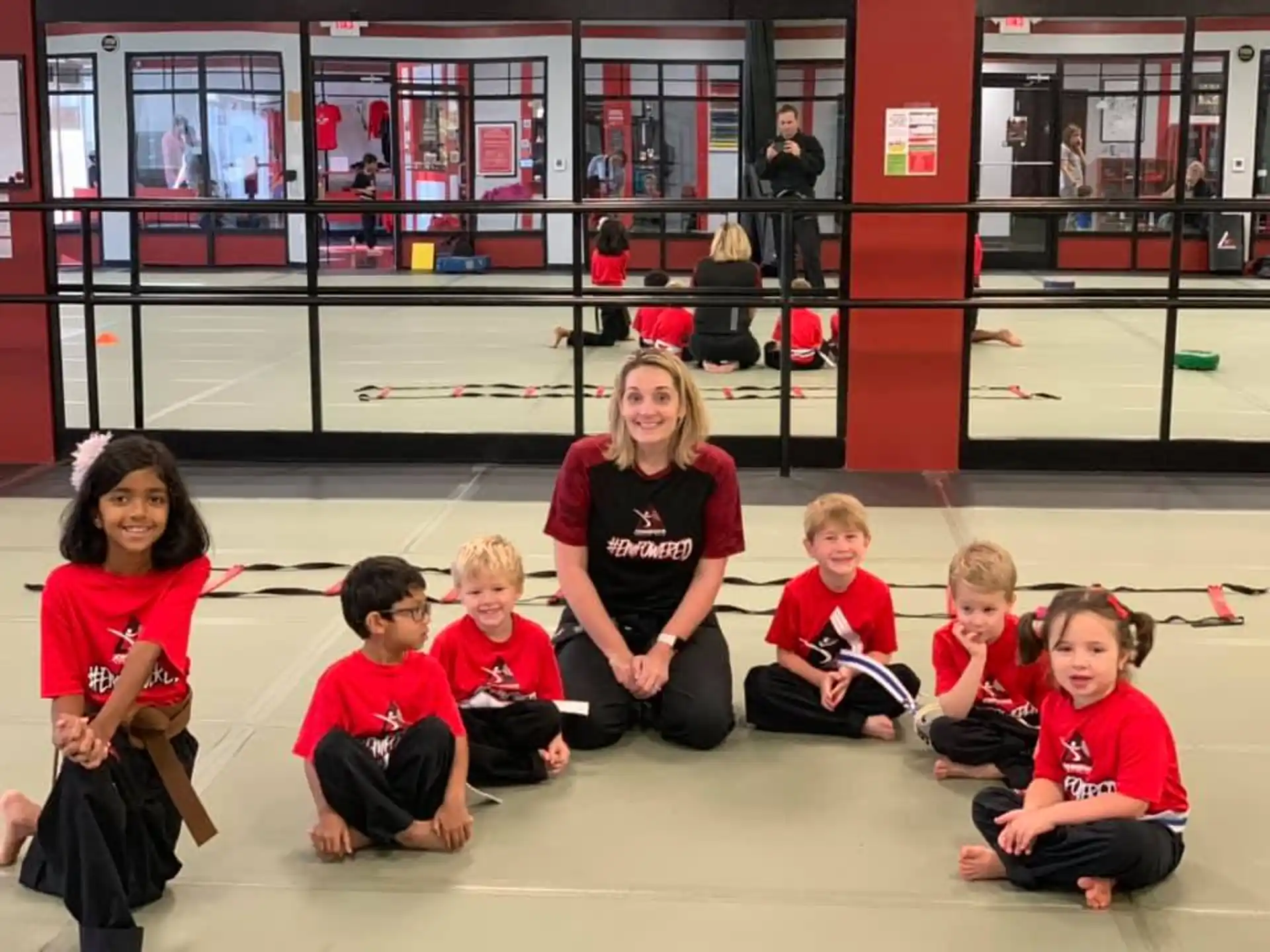 a person and several children sitting on the floor