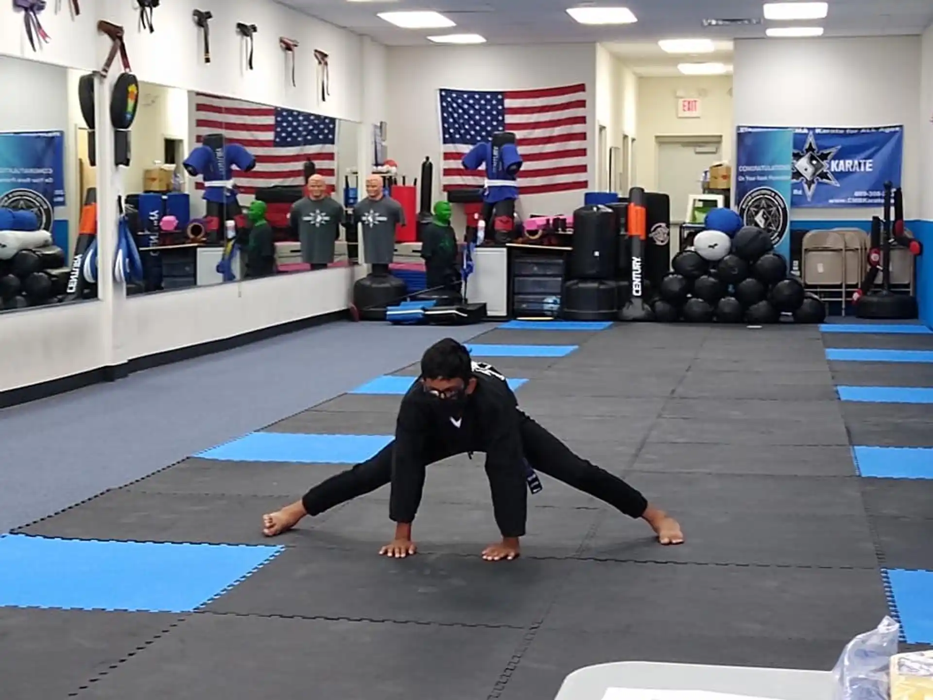 a person doing a plank on a mat in a gym