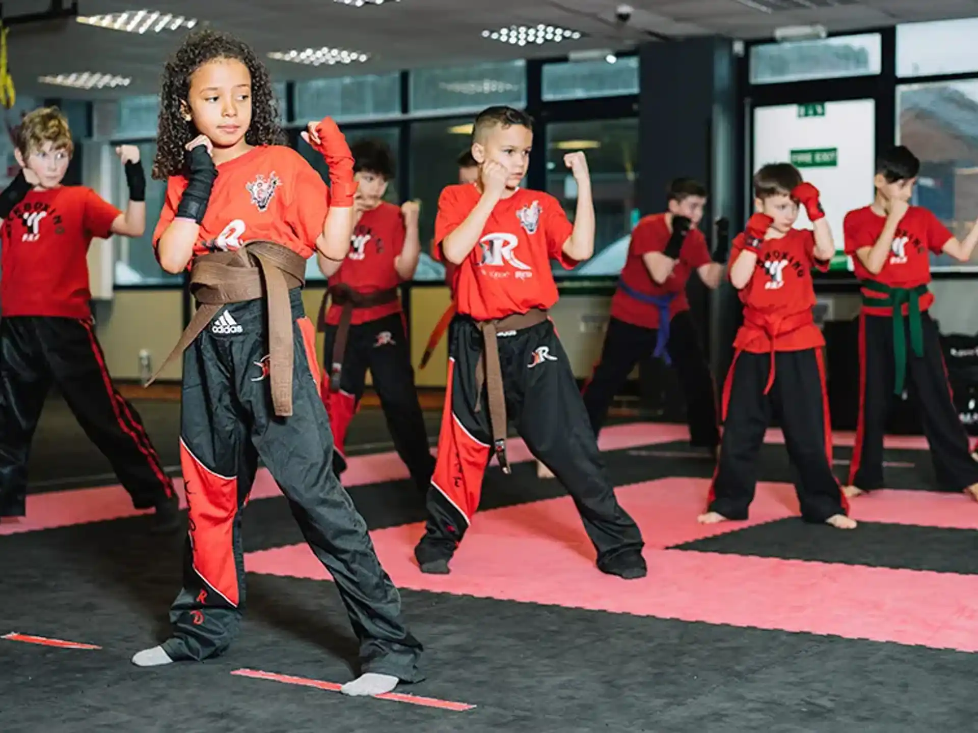 a group of kids in red shirts
