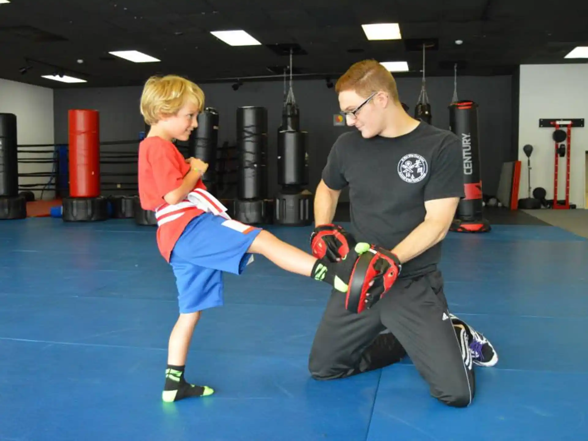a person and a boy in a boxing ring