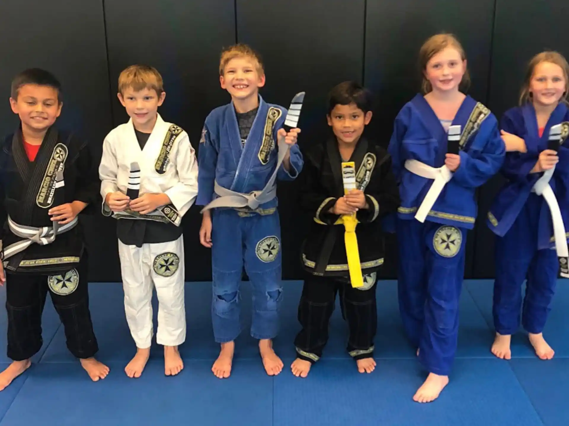 a group of children in karate uniforms