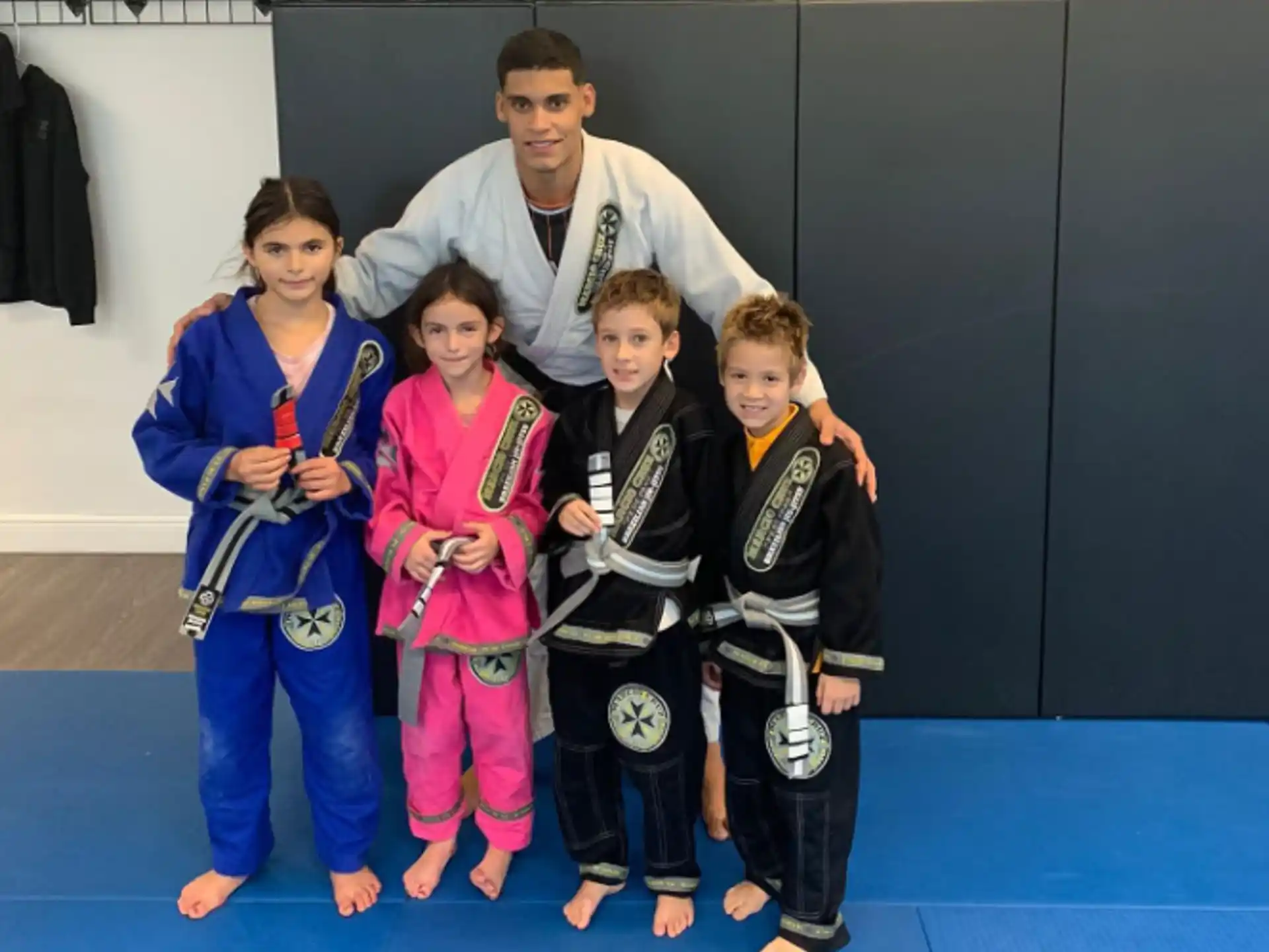 a group of kids in karate uniforms