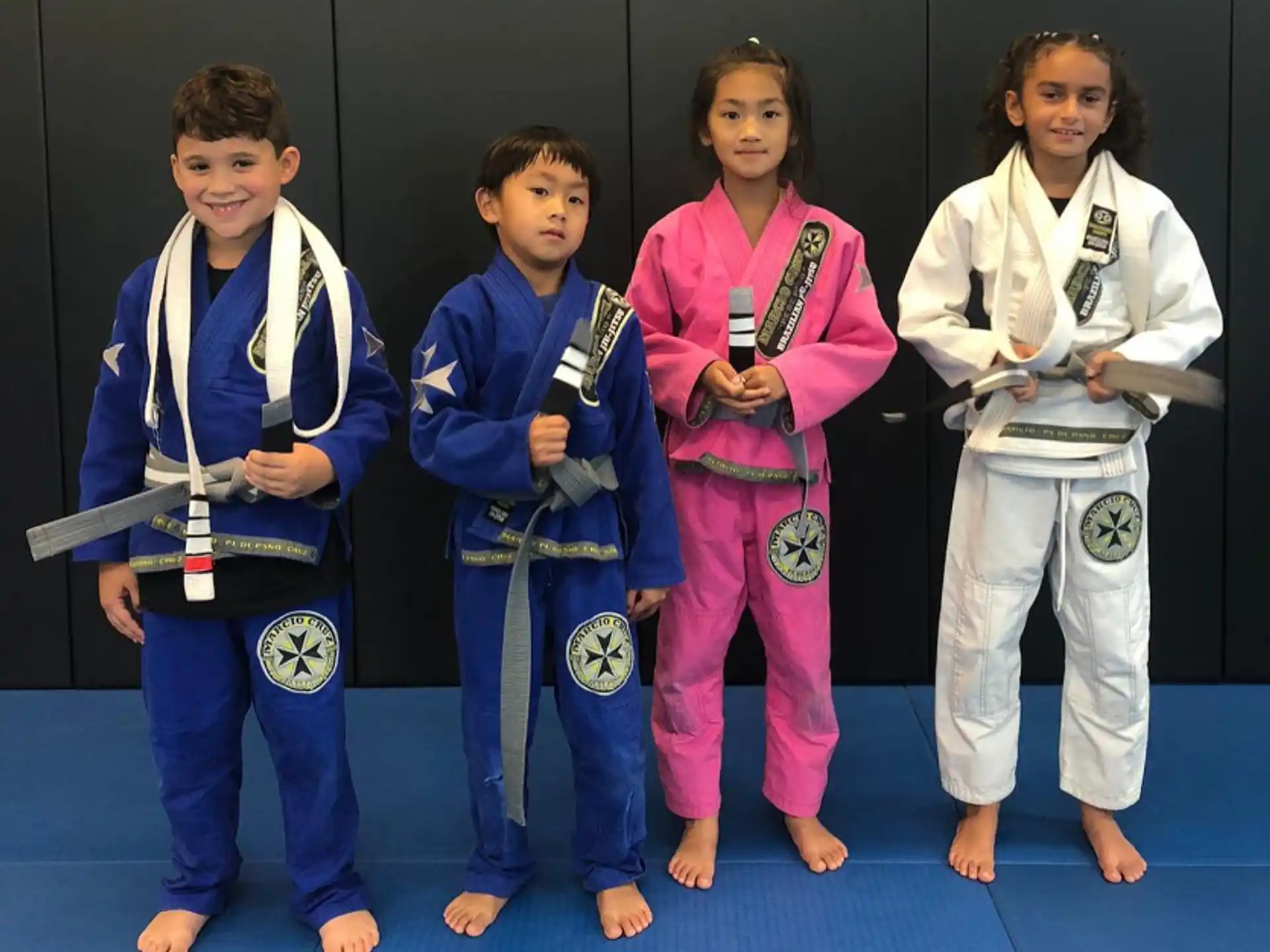 a group of kids wearing karate uniforms