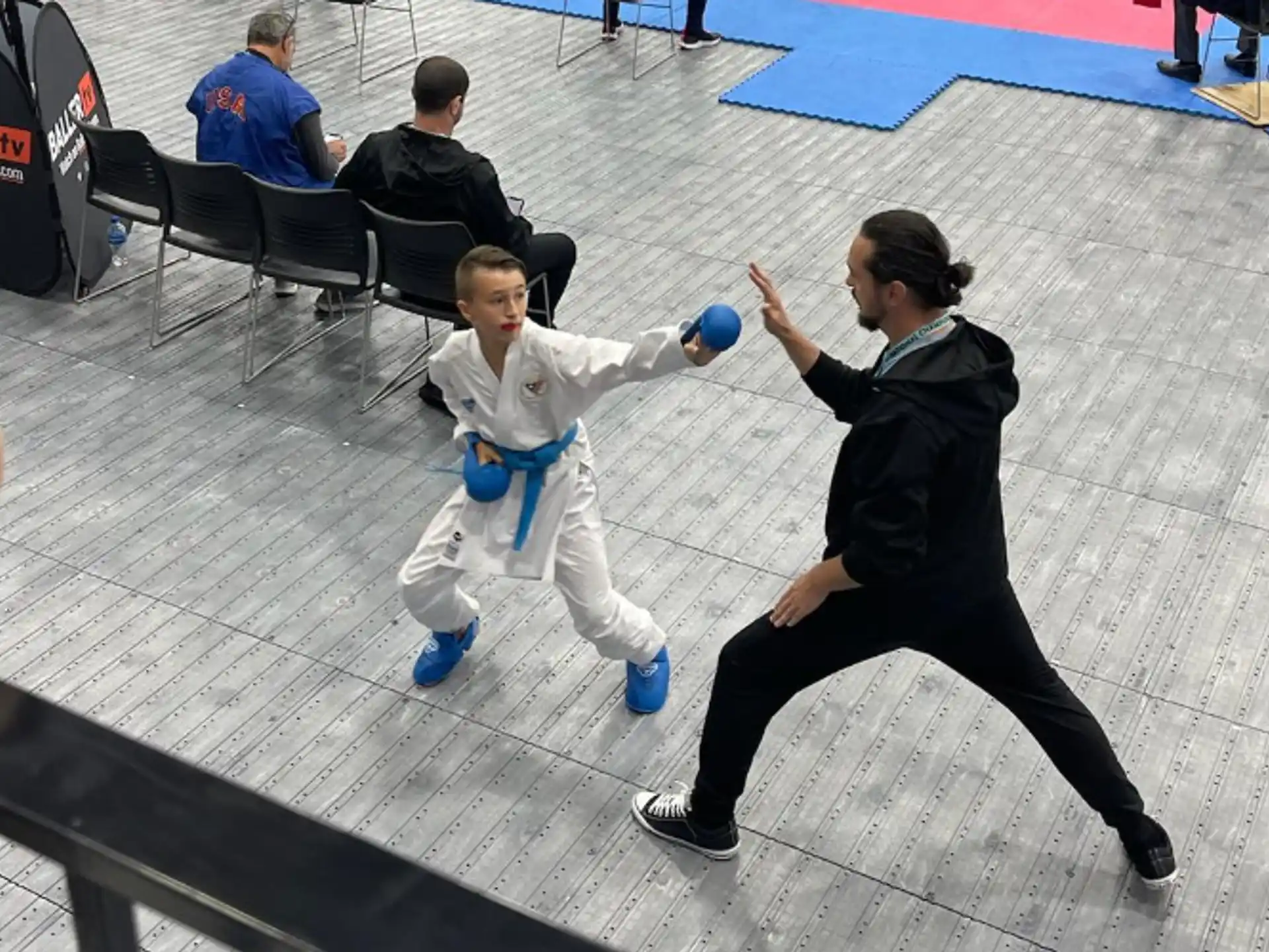 a couple of boys playing with a ball in a gymnasium