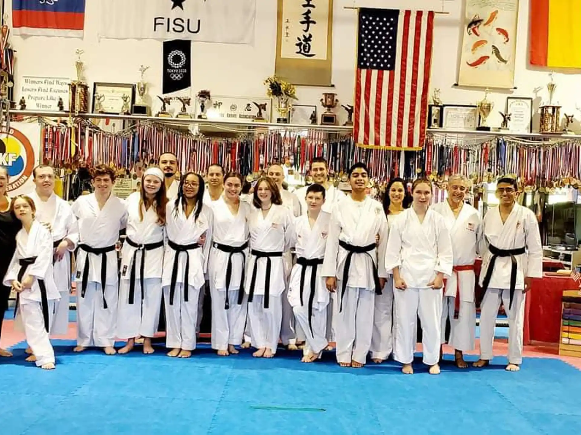 a group of people in white karate uniforms