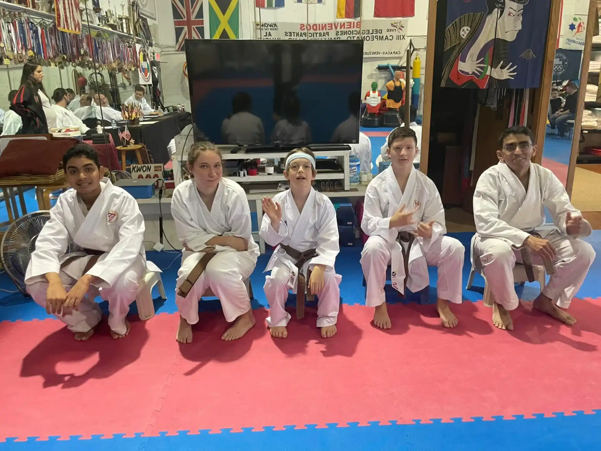 a group of people sitting on a red carpet