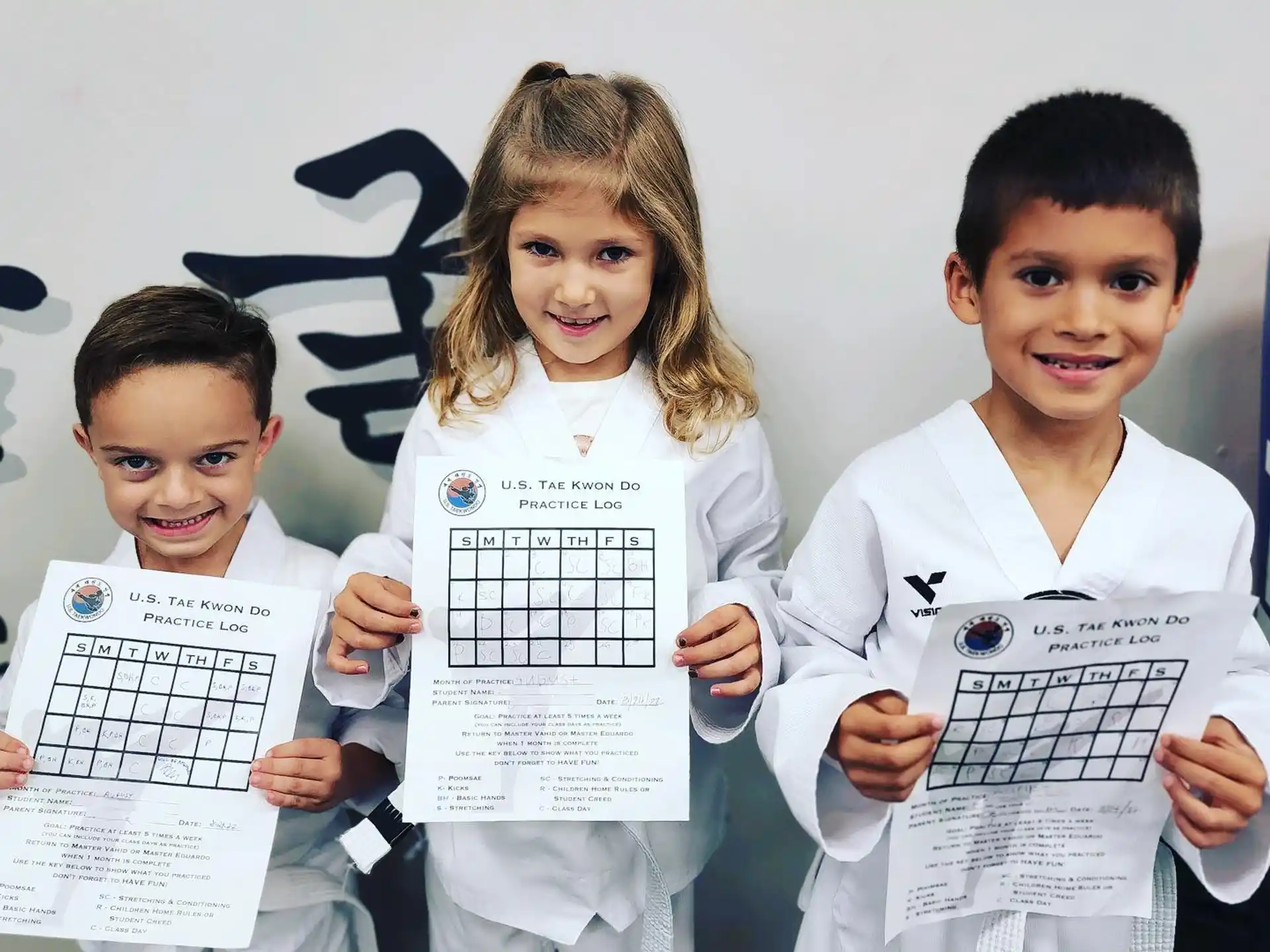 a group of children holding papers