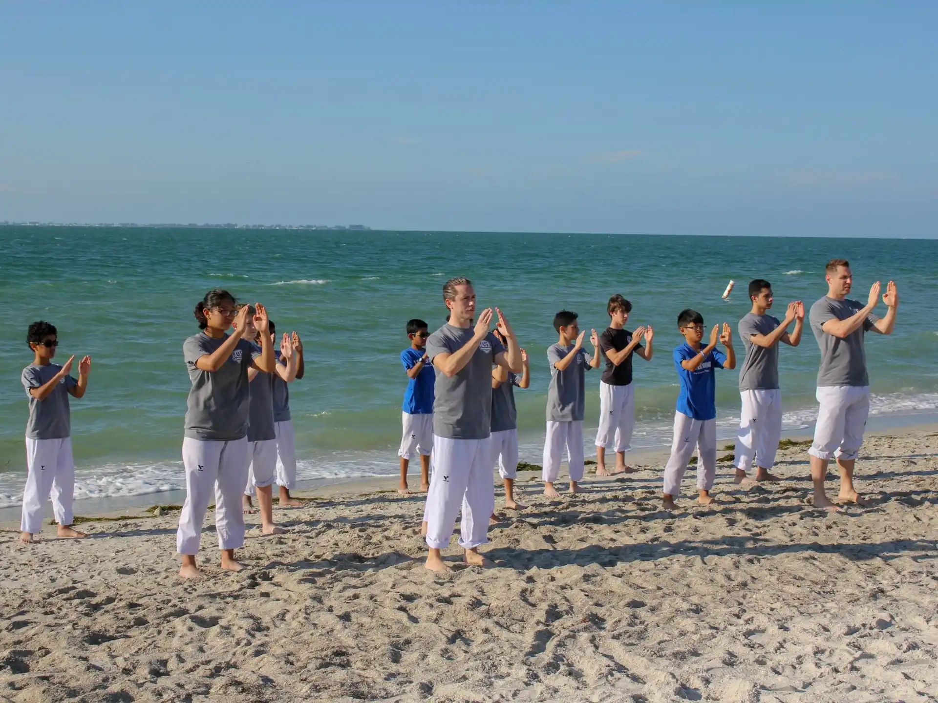 a group of people standing on a beach