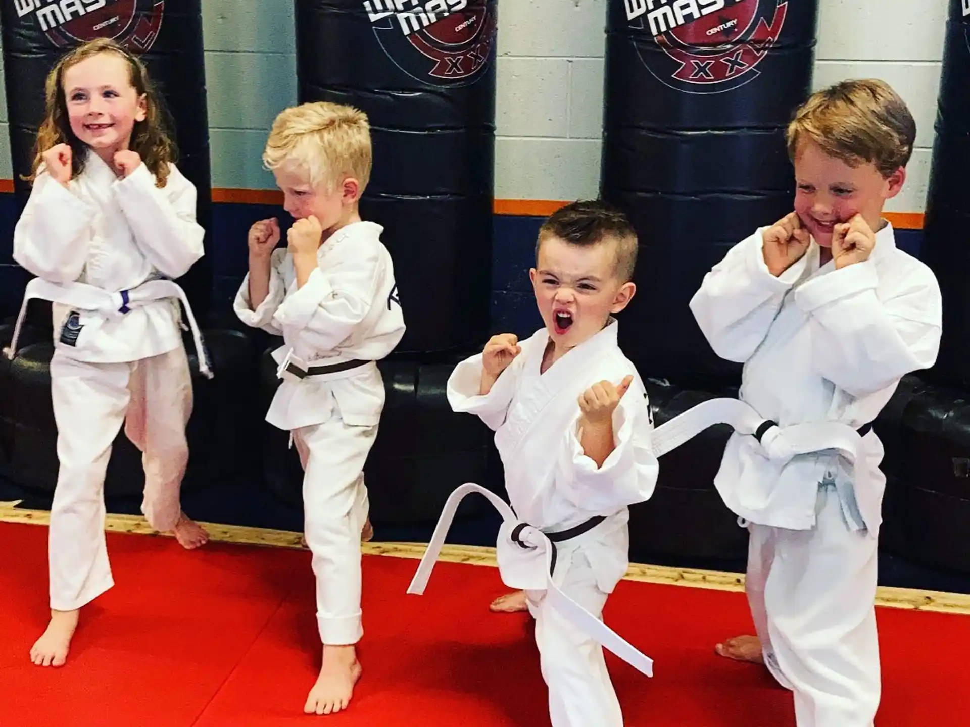 a group of kids in karate uniforms