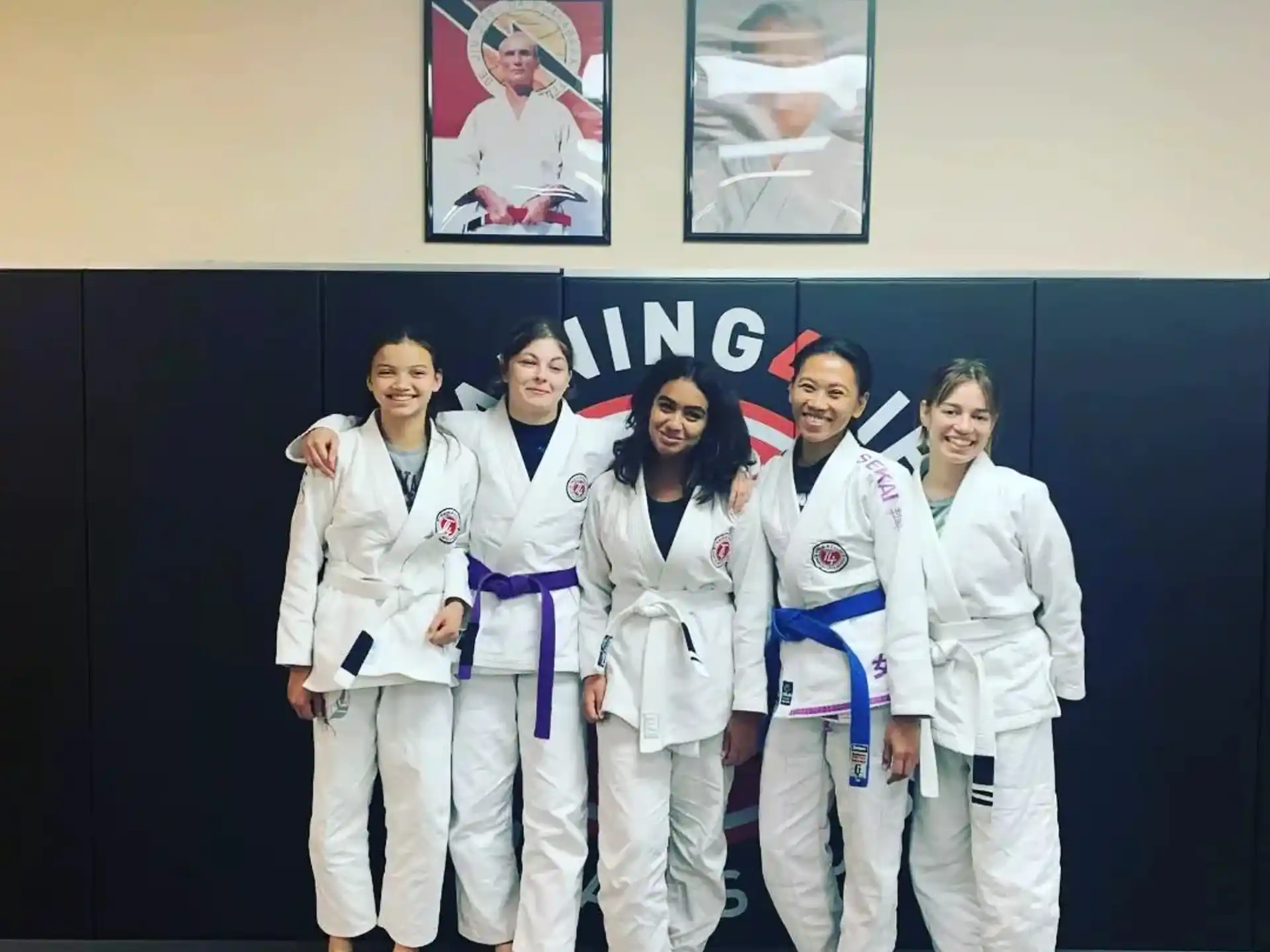 a group of people in white karate uniforms