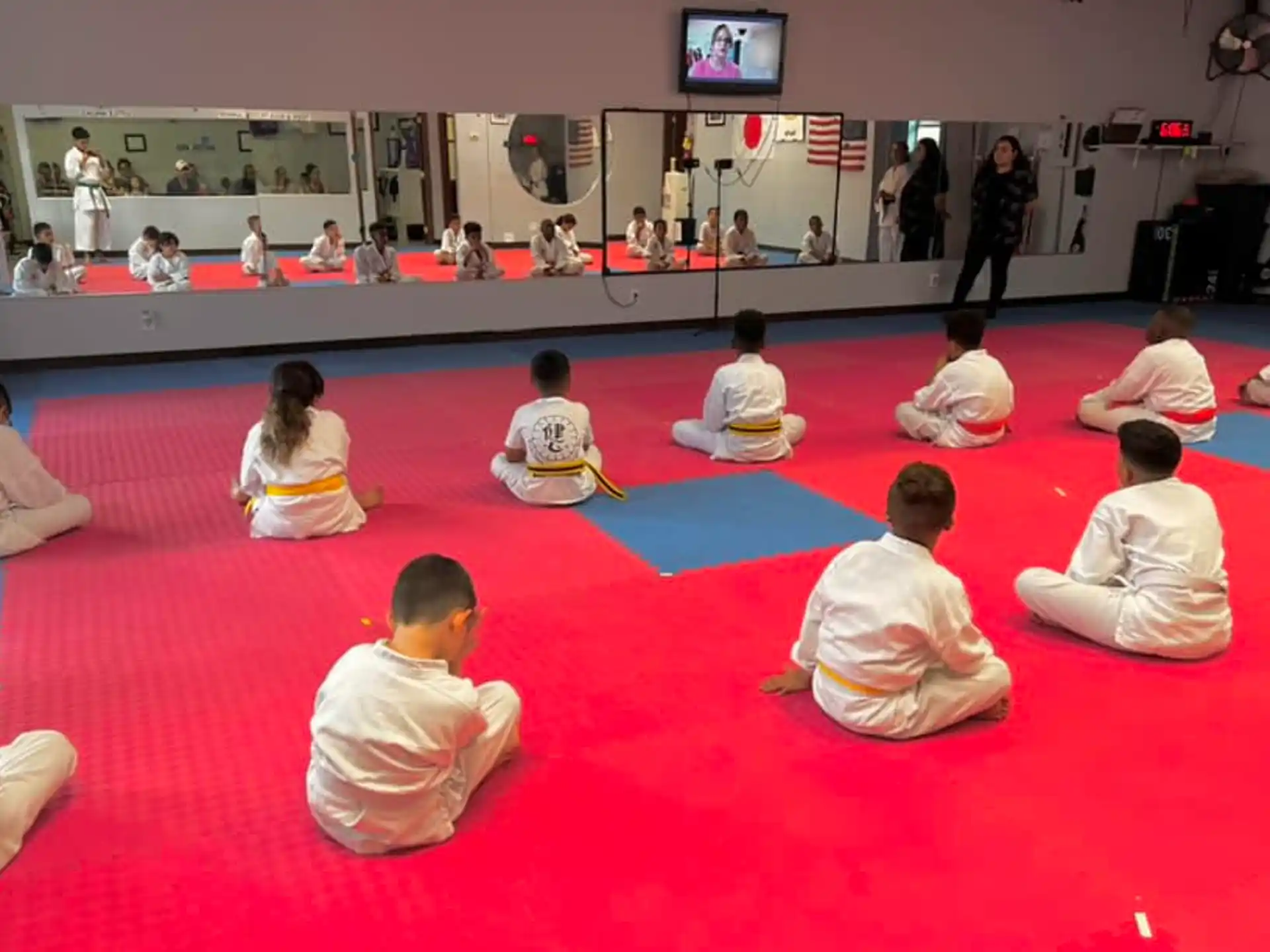 a group of people sitting on the floor in a circle