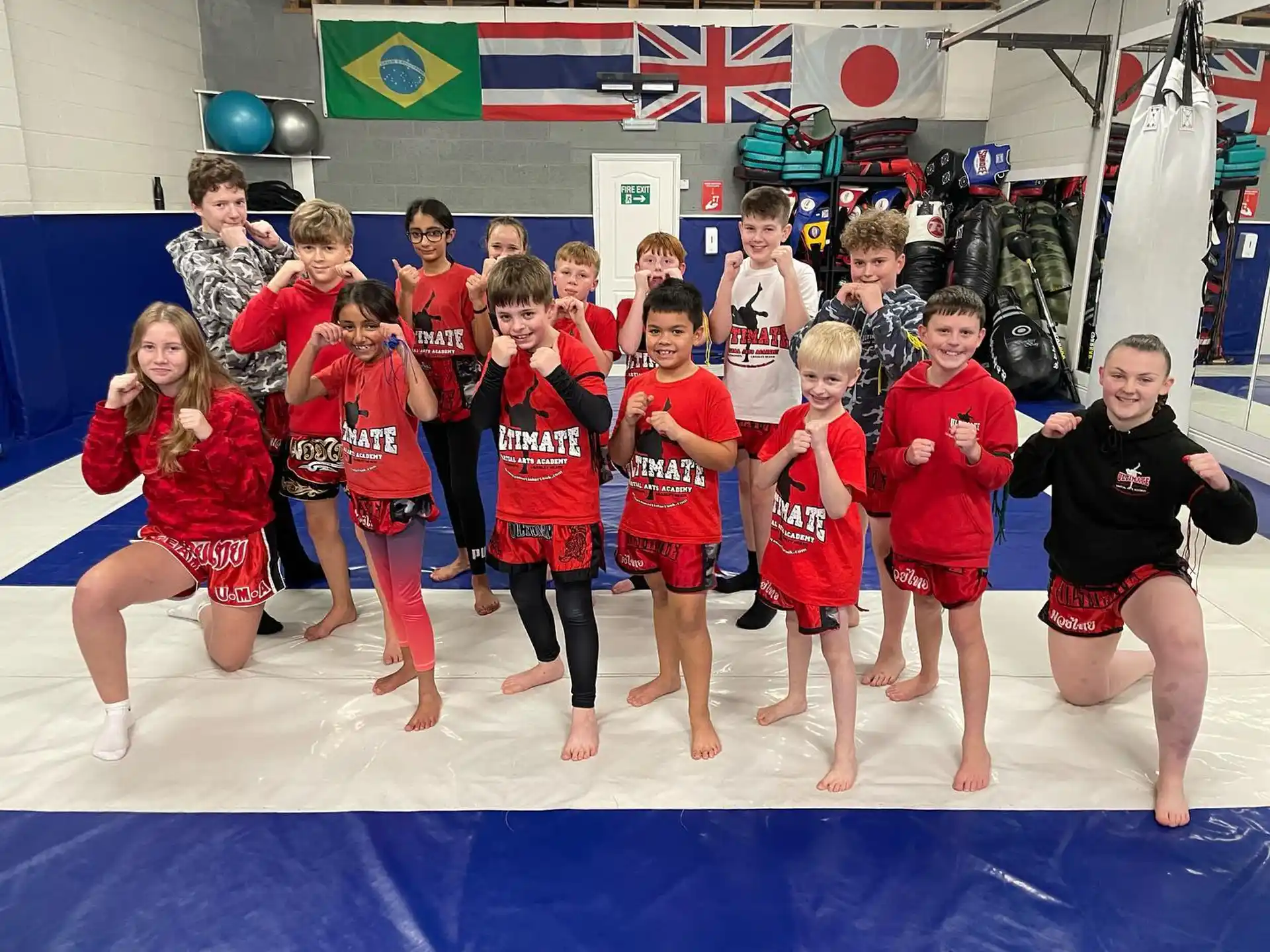 a group of children in red shirts